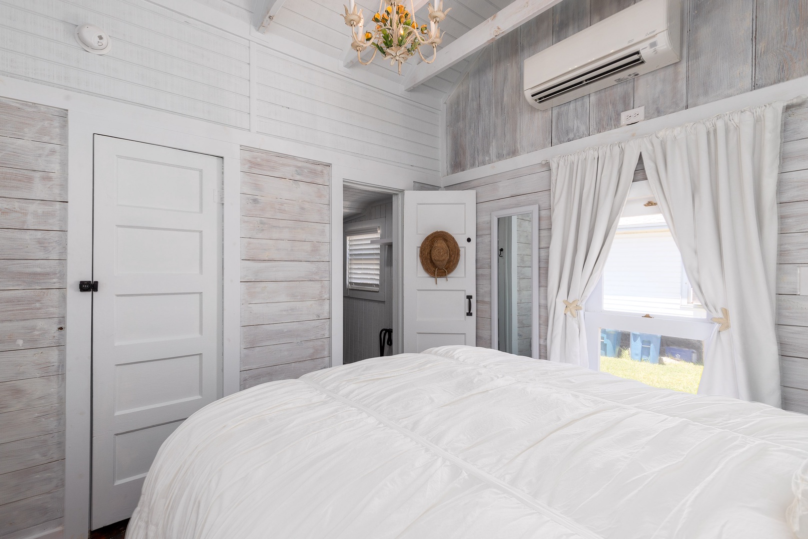 The cozy bedroom offers a plush queen bed and private en suite bathroom