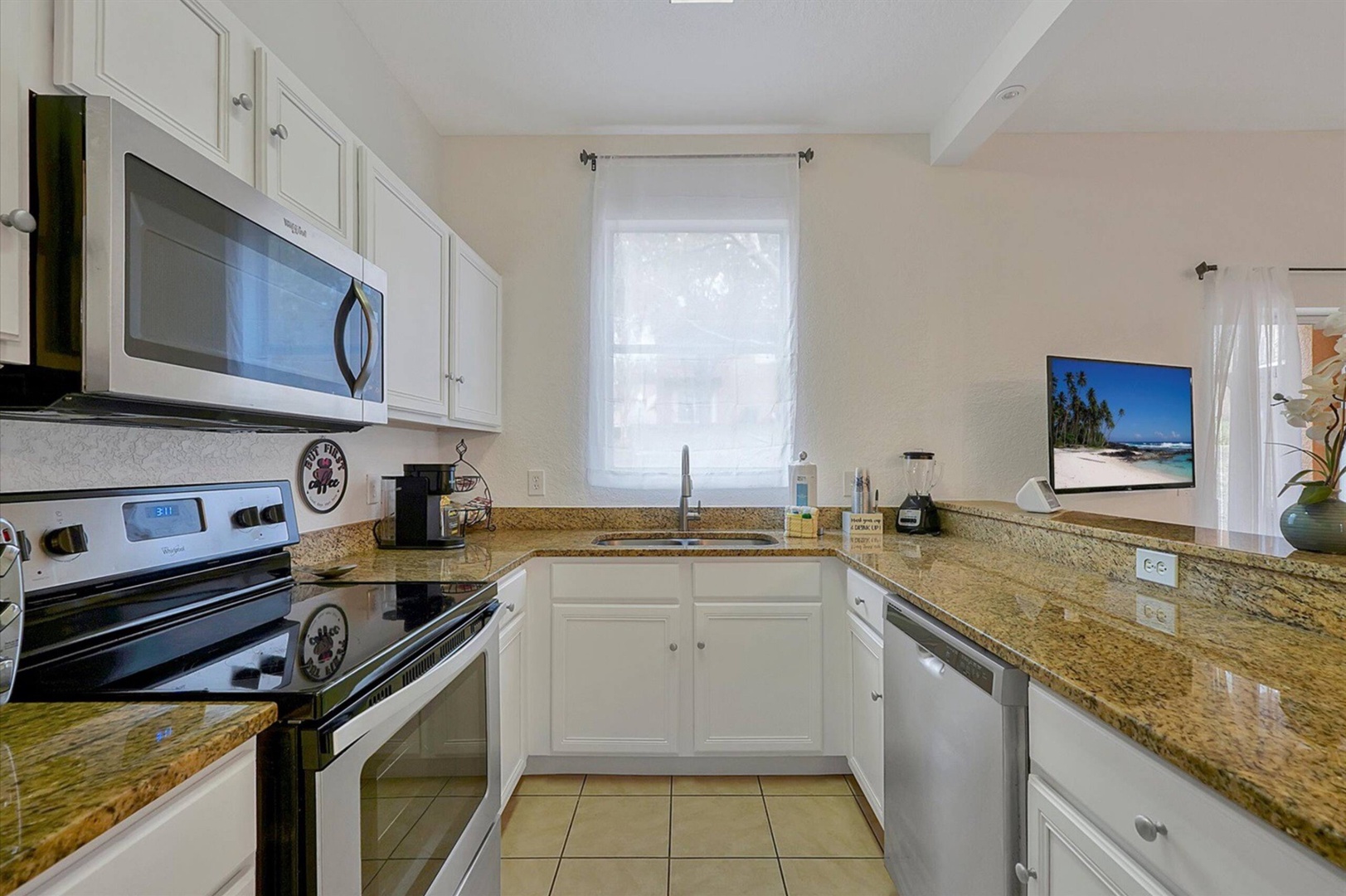 The open, airy kitchen offers ample space & all the comforts of home