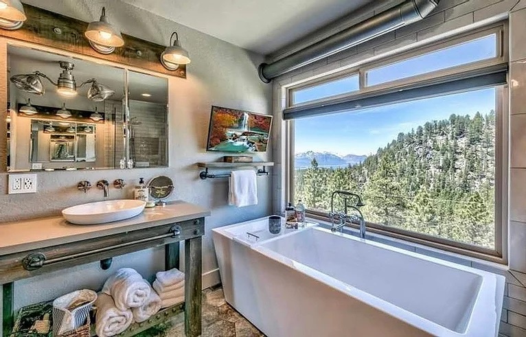 Bathroom with TV, shower, bathtub, and amazing views