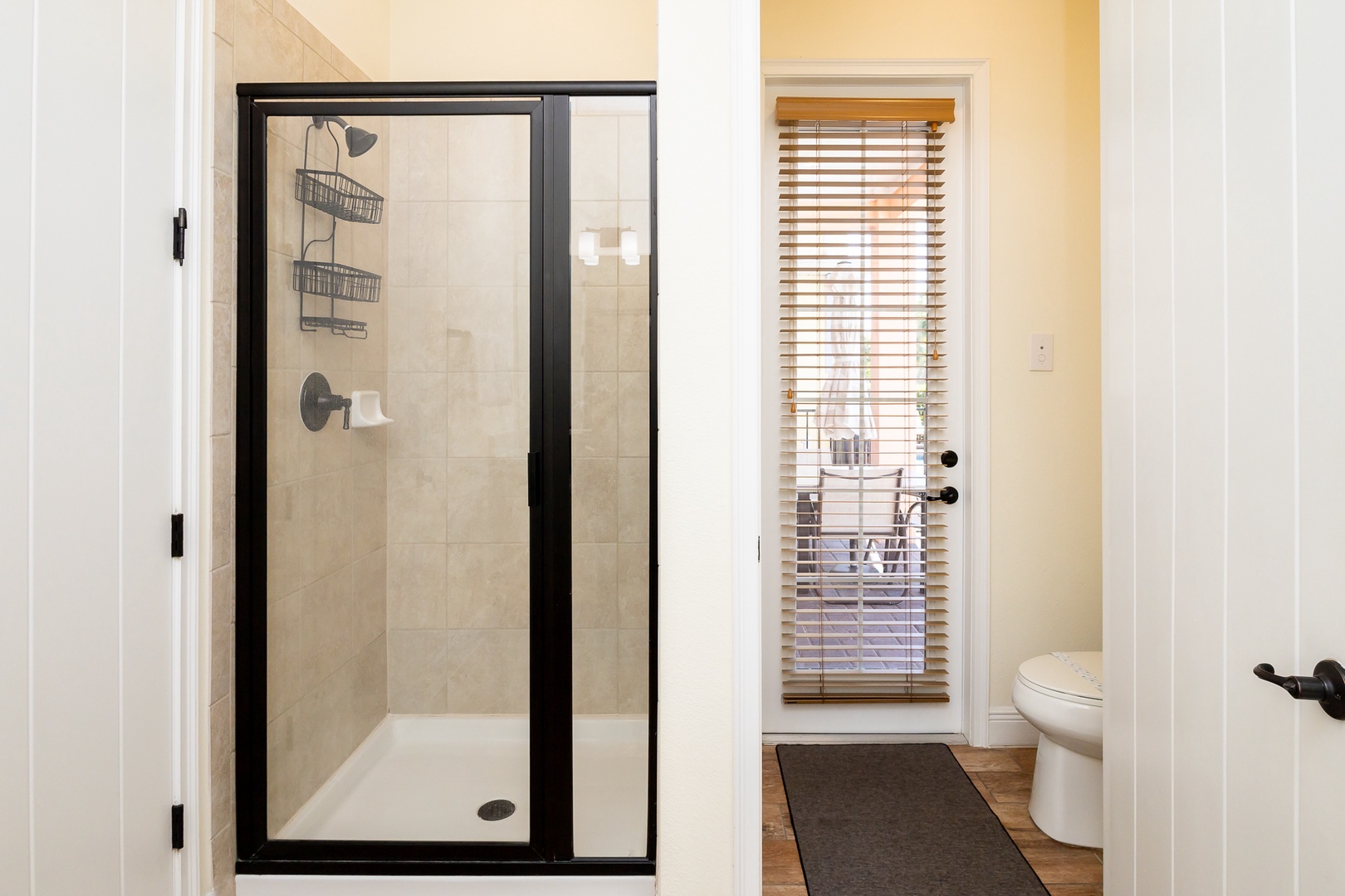 The first-floor ensuite offers a pair of vanities, glass shower, & luxurious tub
