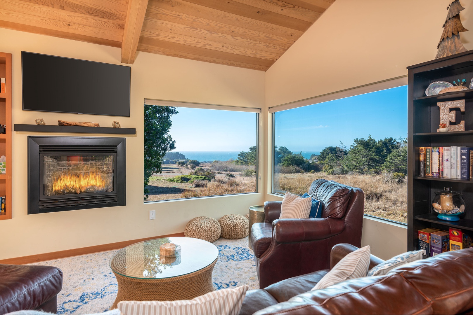 Ocean view living room with fireplace and flat screen TV