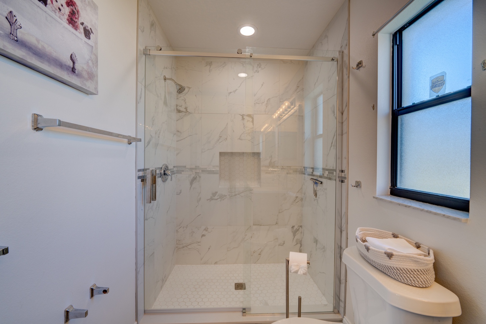 Wash up in this elegant ensuite, featuring a single vanity & walk-in shower