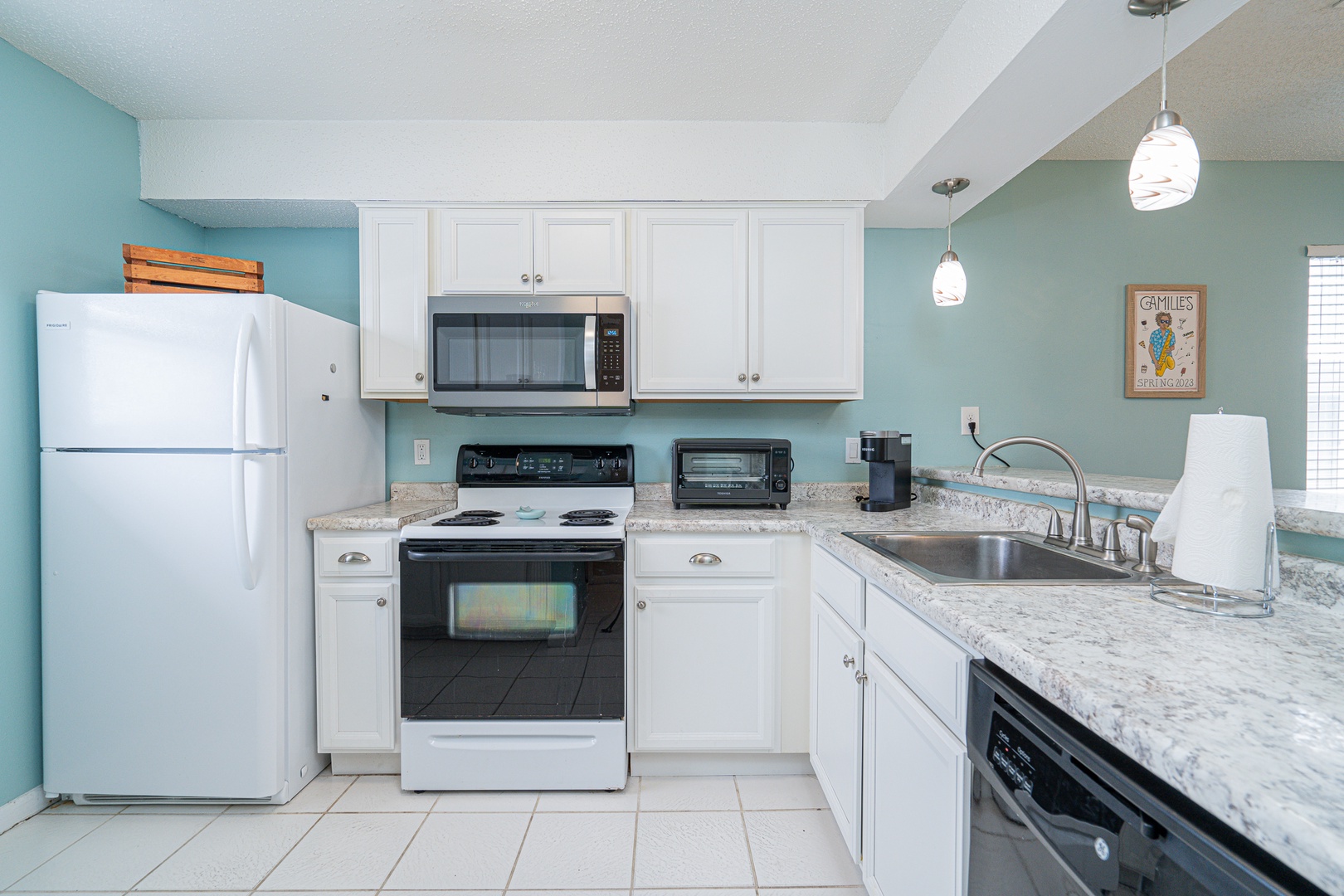 The open, breezy kitchen offers ample space & all the comforts of home