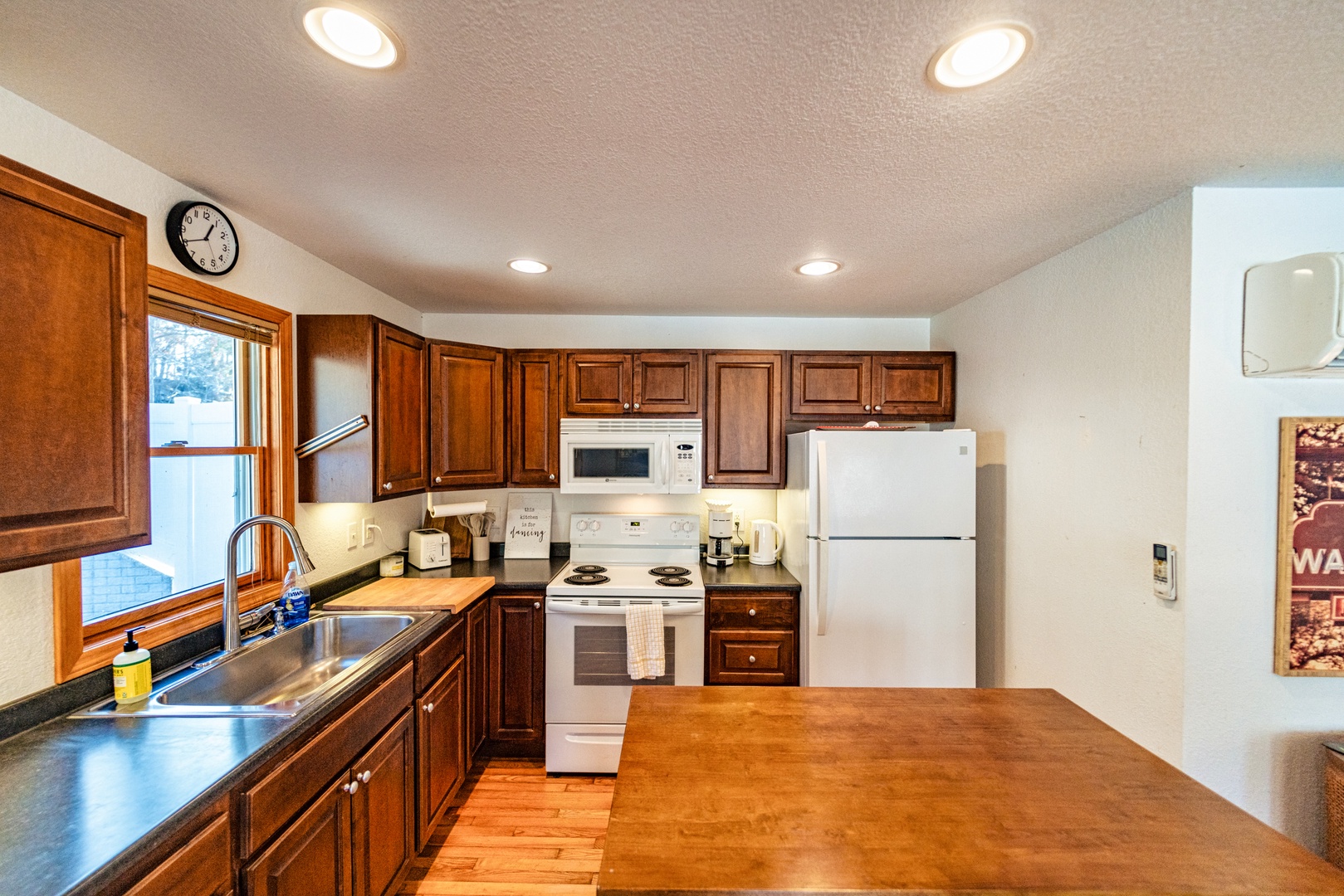 The cozy, open kitchen offers ample space & all the comforts of home