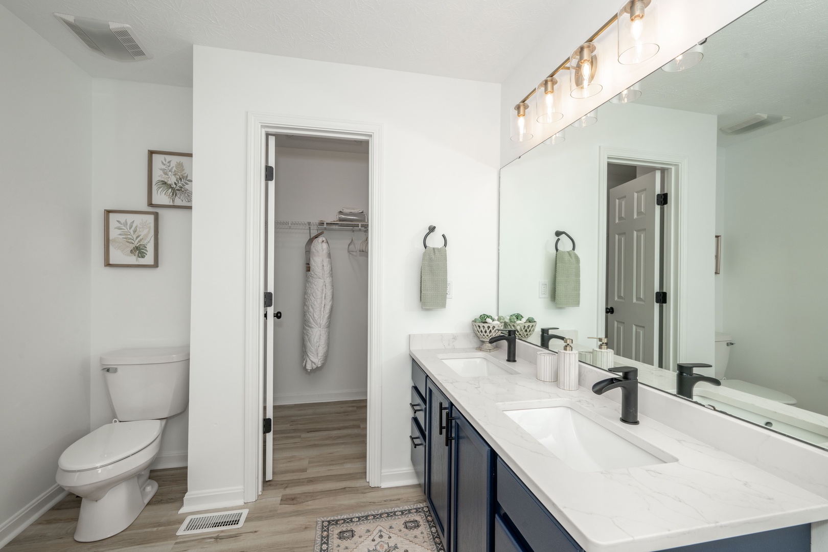 This full ensuite offers a double vanity, closet, soaking tub and shower