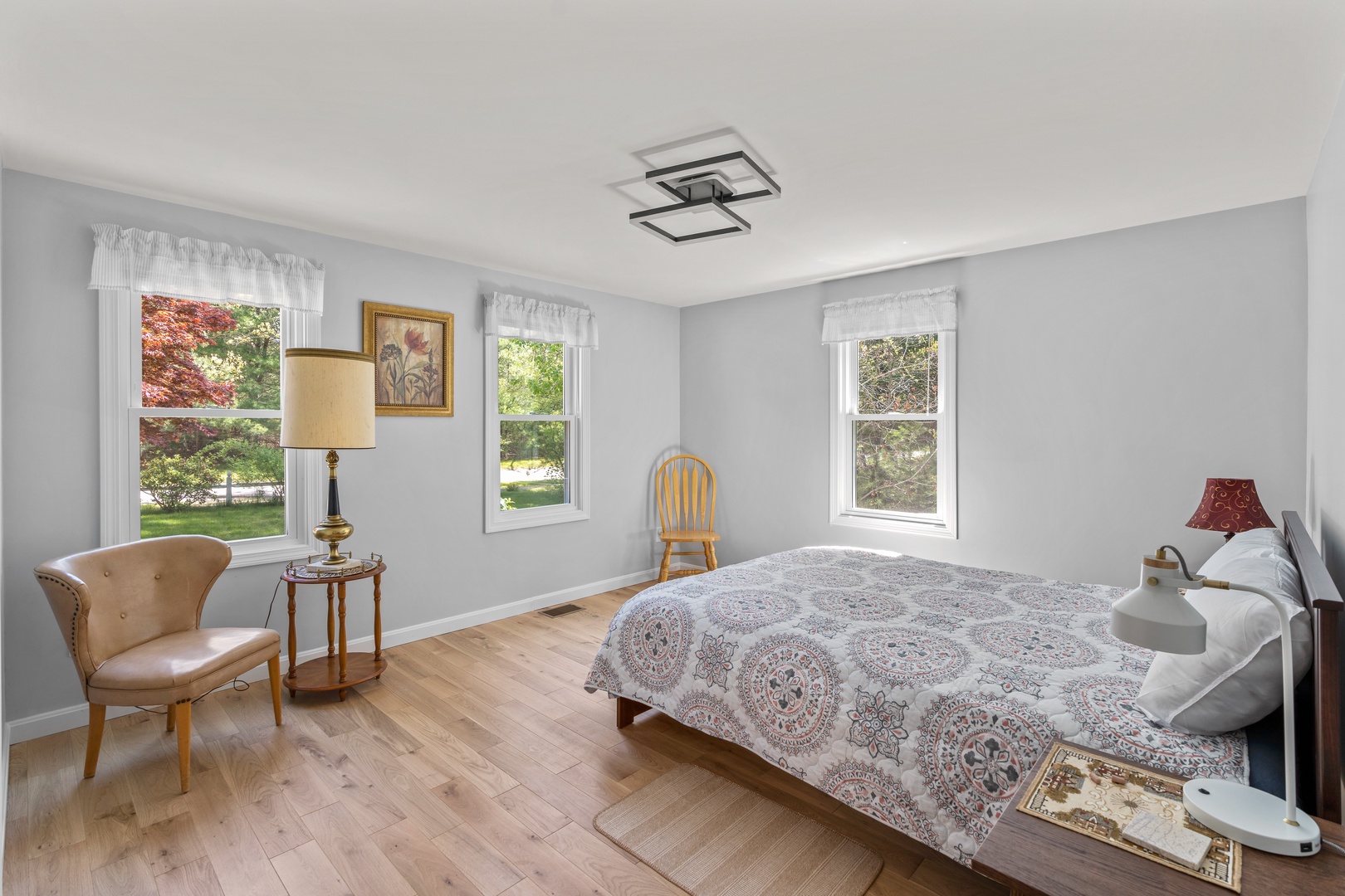 This serene main-floor bedroom features a cozy queen-sized bed