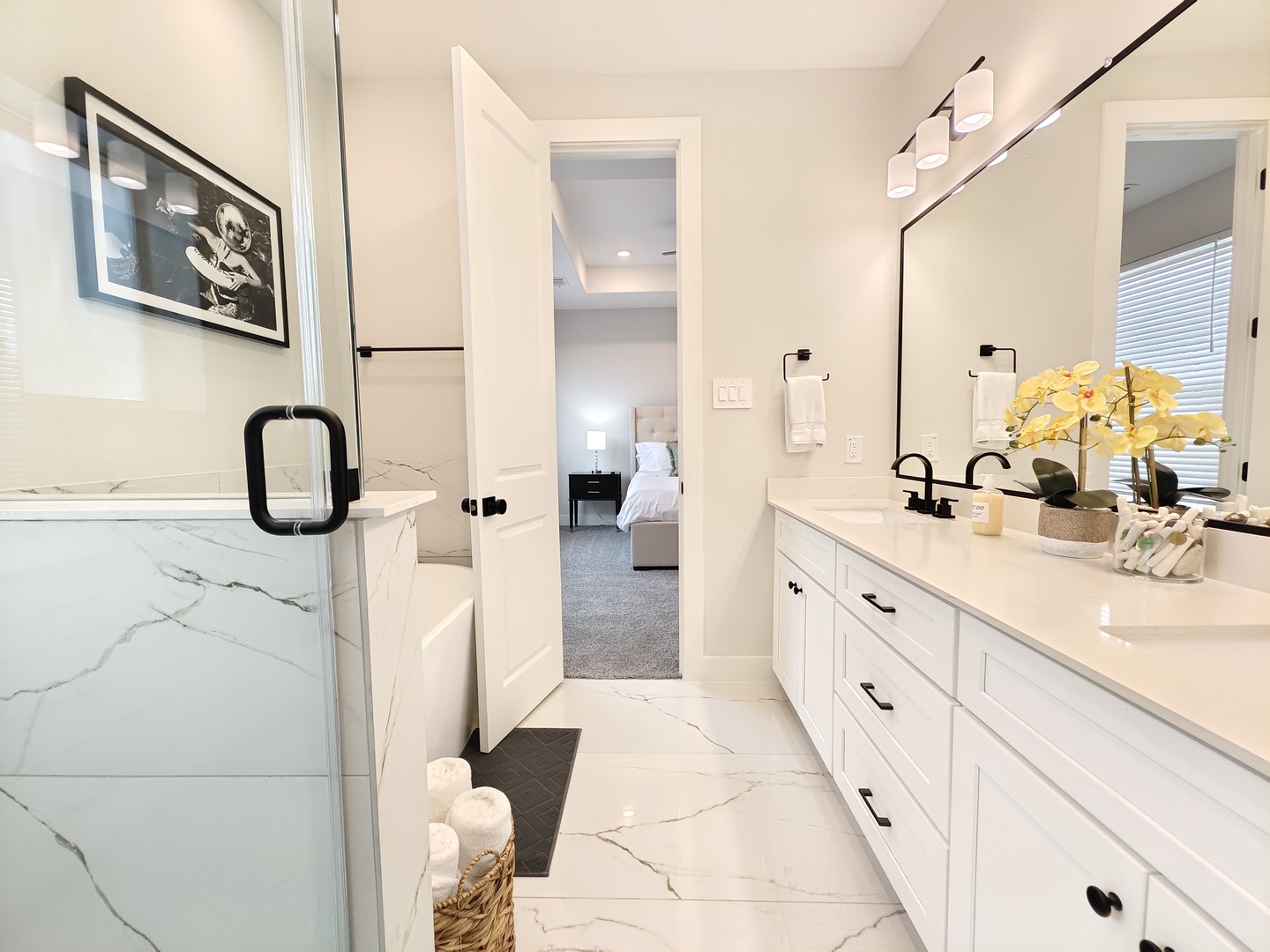 The master ensuite features a double vanity, glass shower, & soaking tub