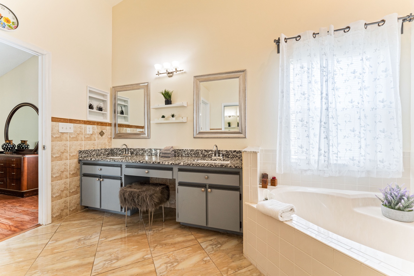 Enjoy a double vanity, shower, & soaking tub in this ensuite bath