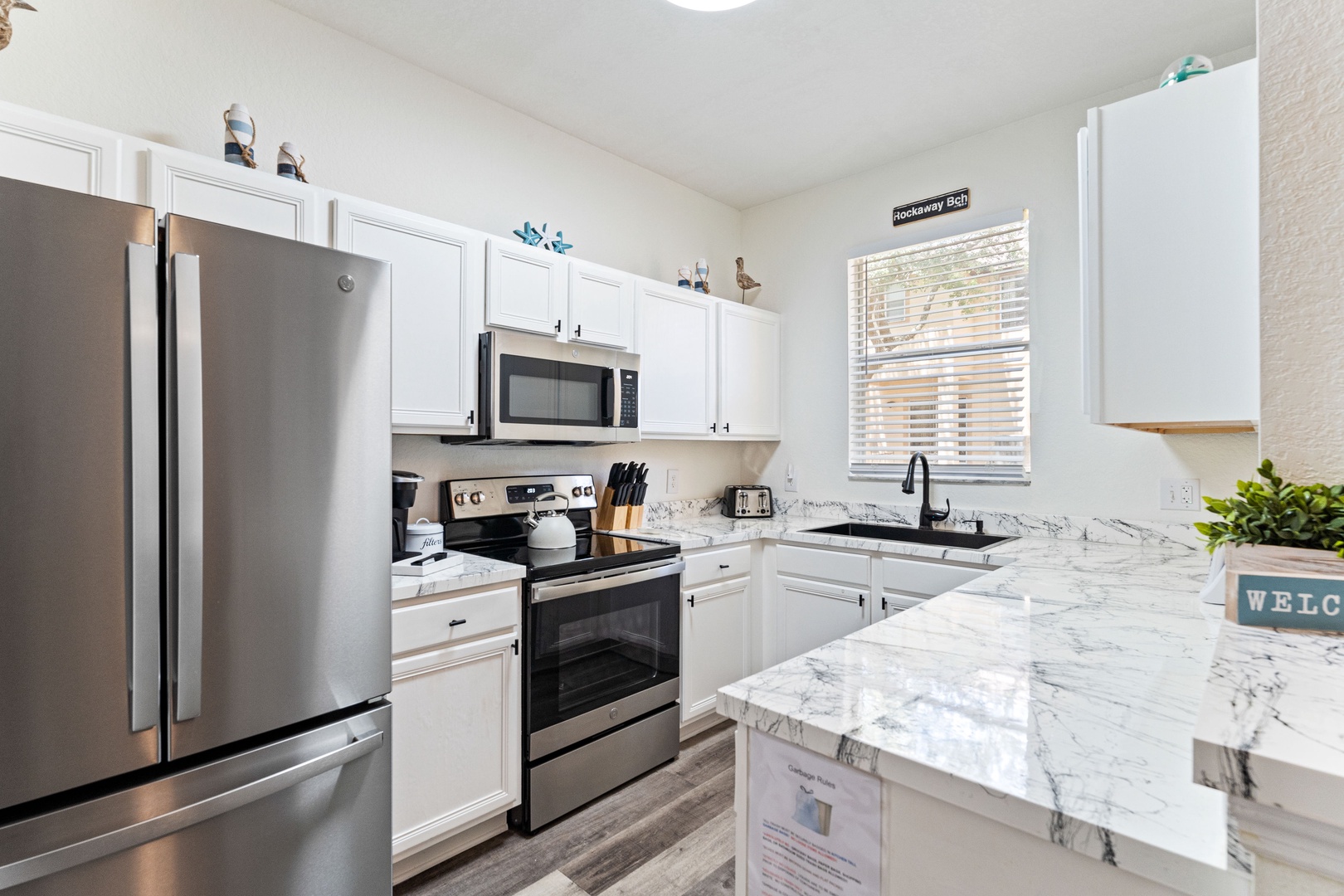 The airy kitchen offers ample space & all the comforts of home