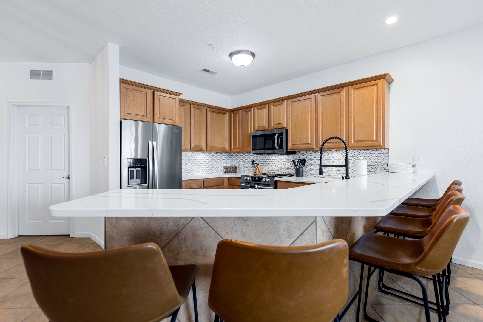 Sip morning coffee or grab a bite at the kitchen counter, with seating for 6