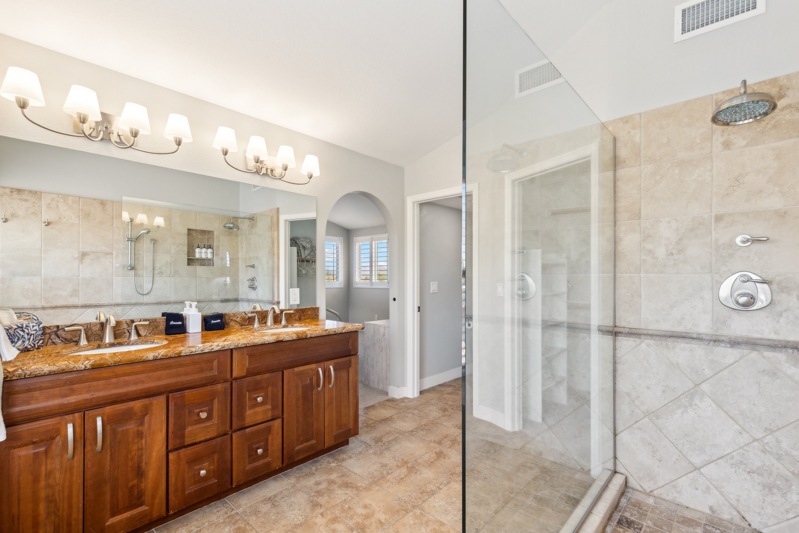 Ensuite bathroom with dual sinks, and walk-in shower with dual shower heads