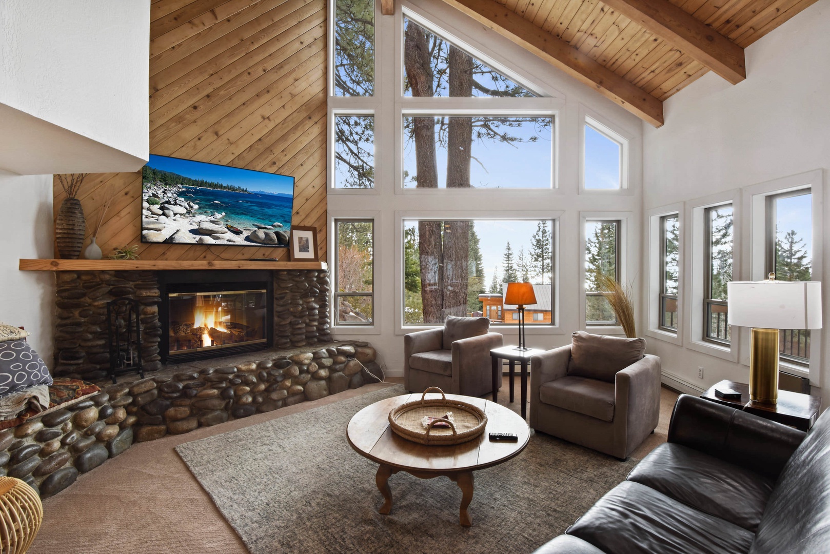 Living room w/ Smart TV, DVD player, wood burning fireplace and deck access