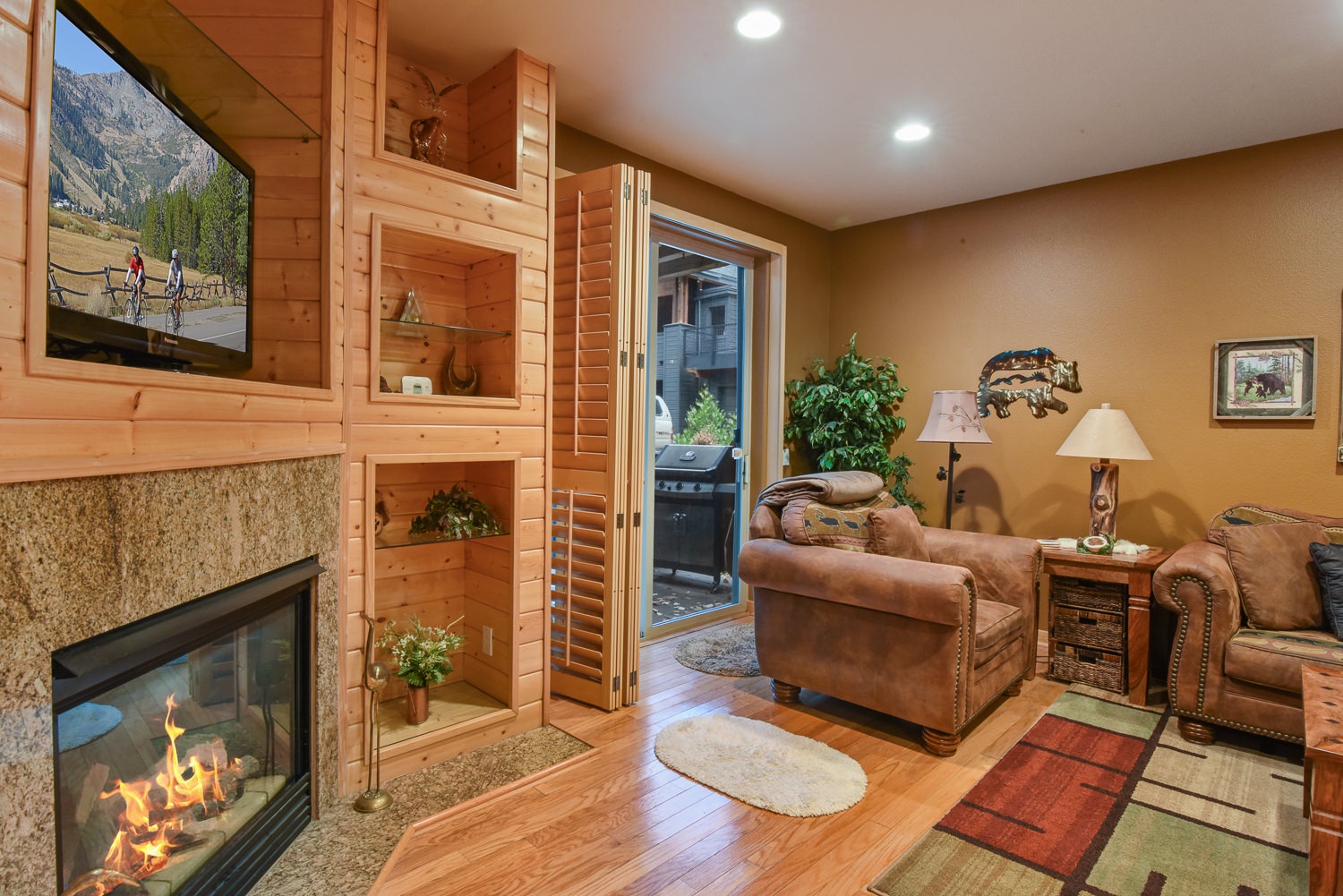 Open living space with ample seating, fireplace, Smart TV, and patio access