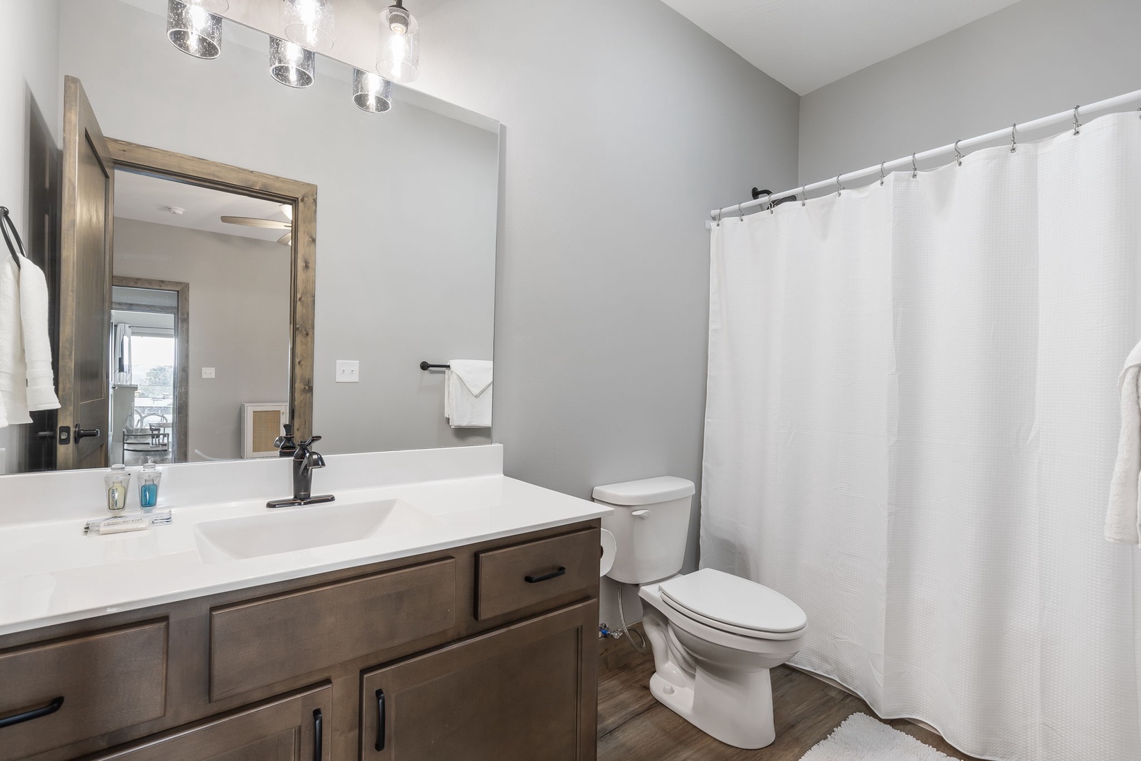 This serene ensuite offers a single vanity & shower/tub combo