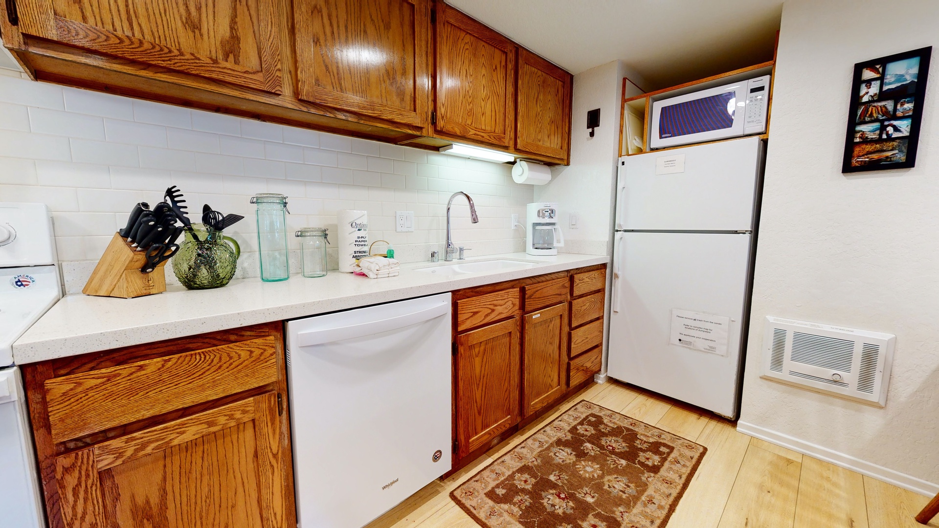 Kitchen with toaster, drip coffee maker, blender, electric stovetop and more