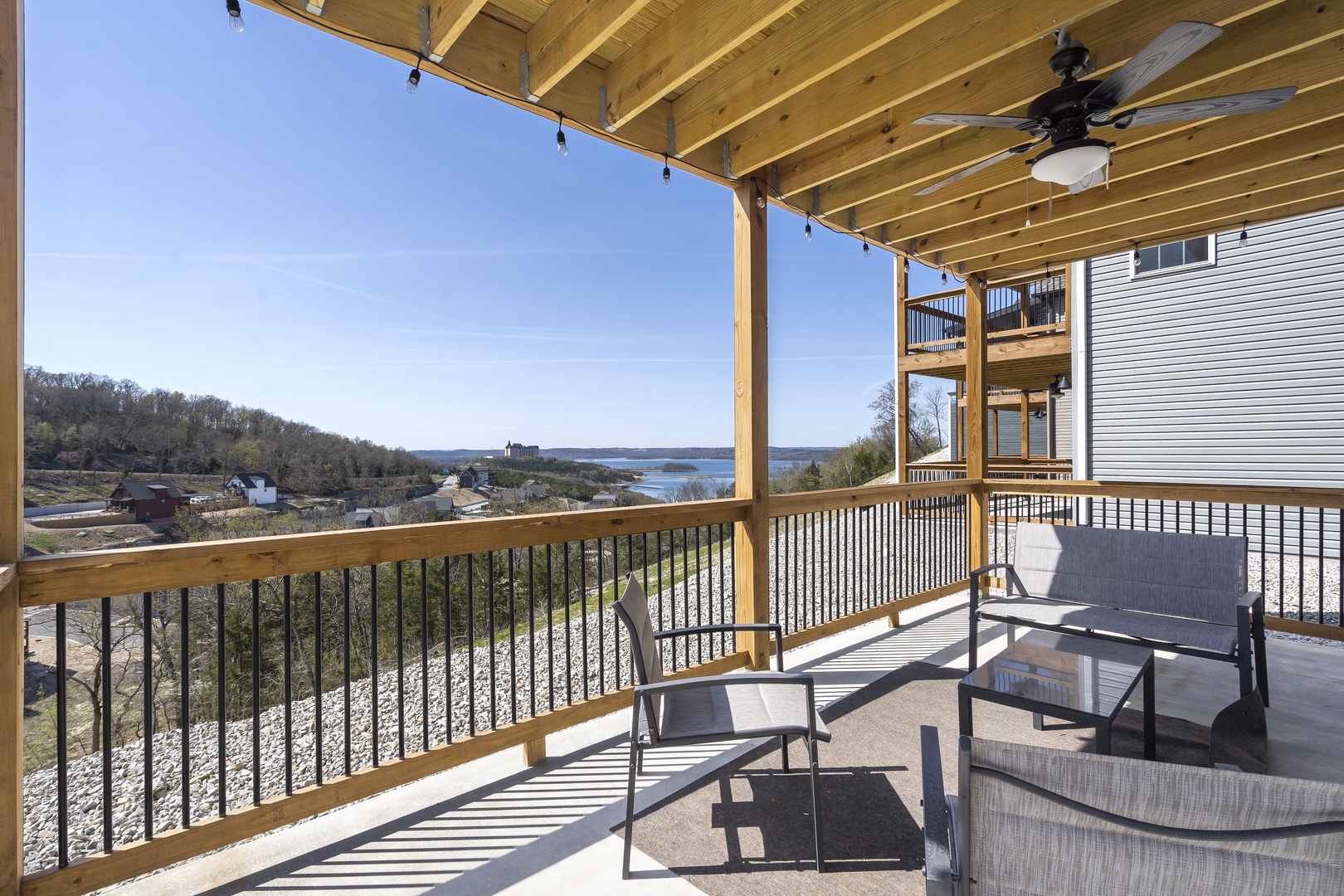 Large lower level deck with lake view, and out door seating