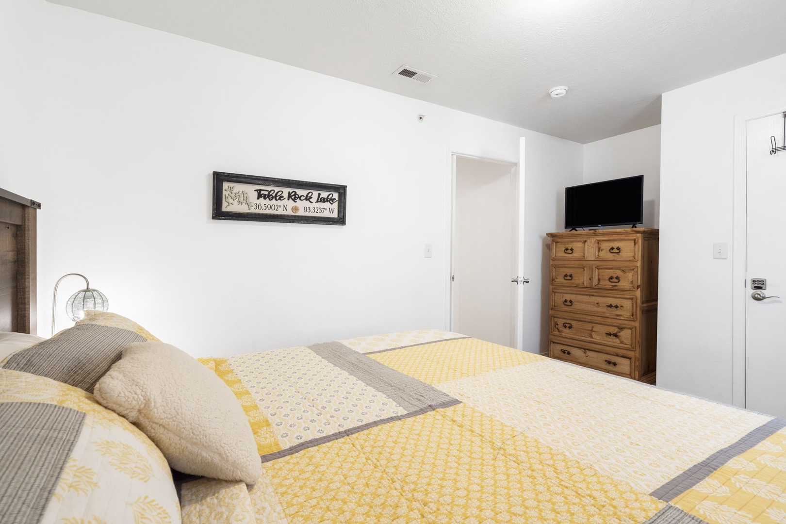 The first of three bedrooms offers a cozy king bed & Smart TV