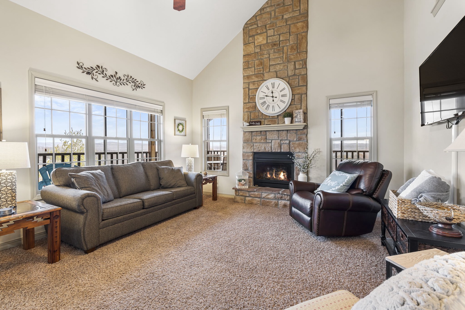 Open living space with, sofa sleeper, Smart TV, fireplace, and screened deck access