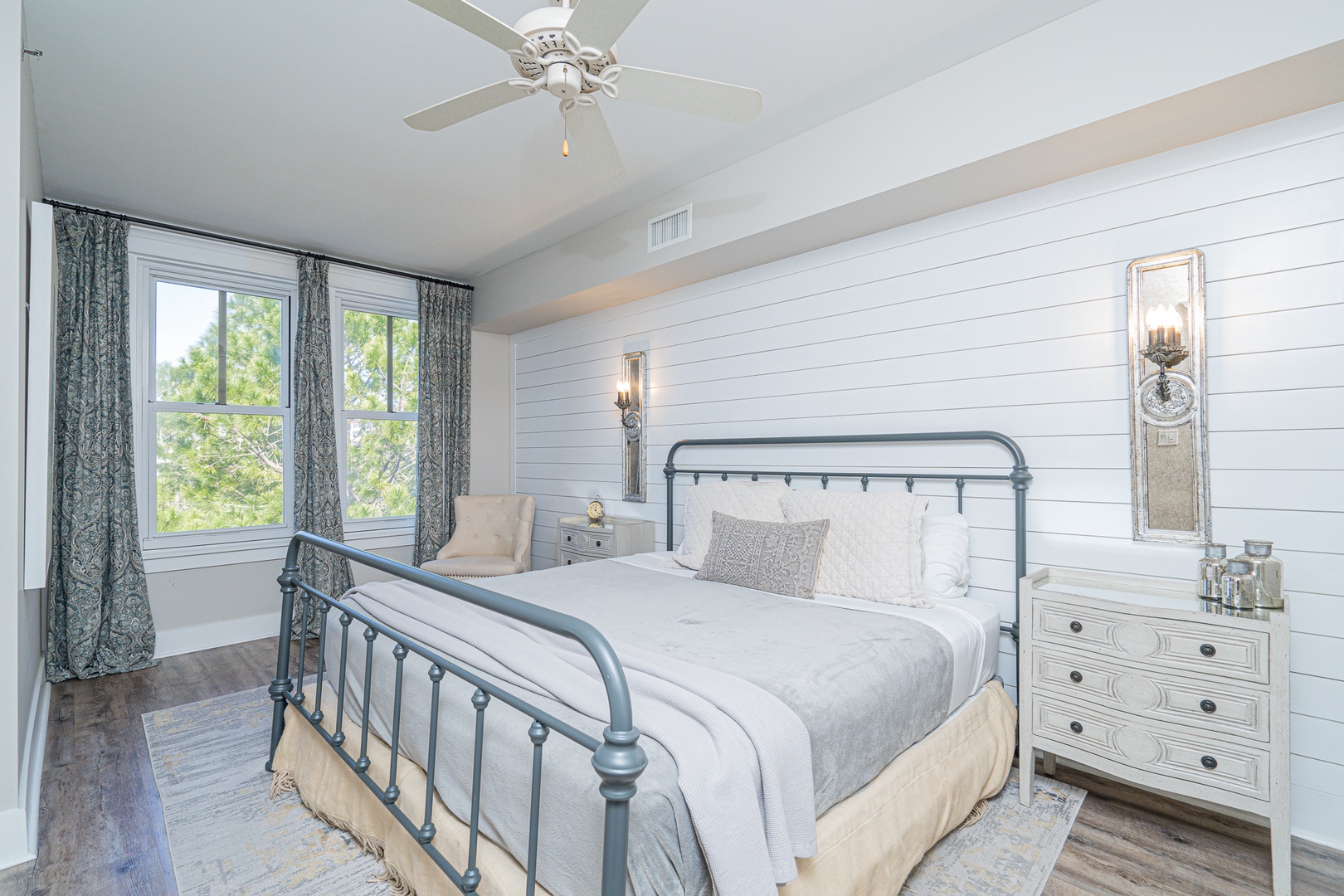 The serene master suite boasts a plush king bed, private ensuite, & TV