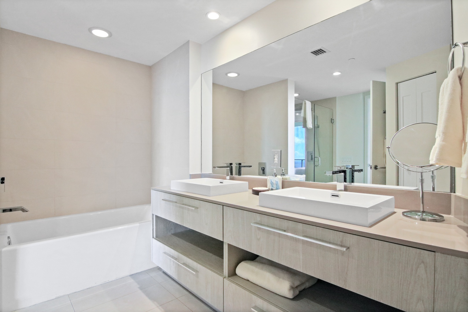 The second king en suite offers a double vanity, glass shower, & soaking tub