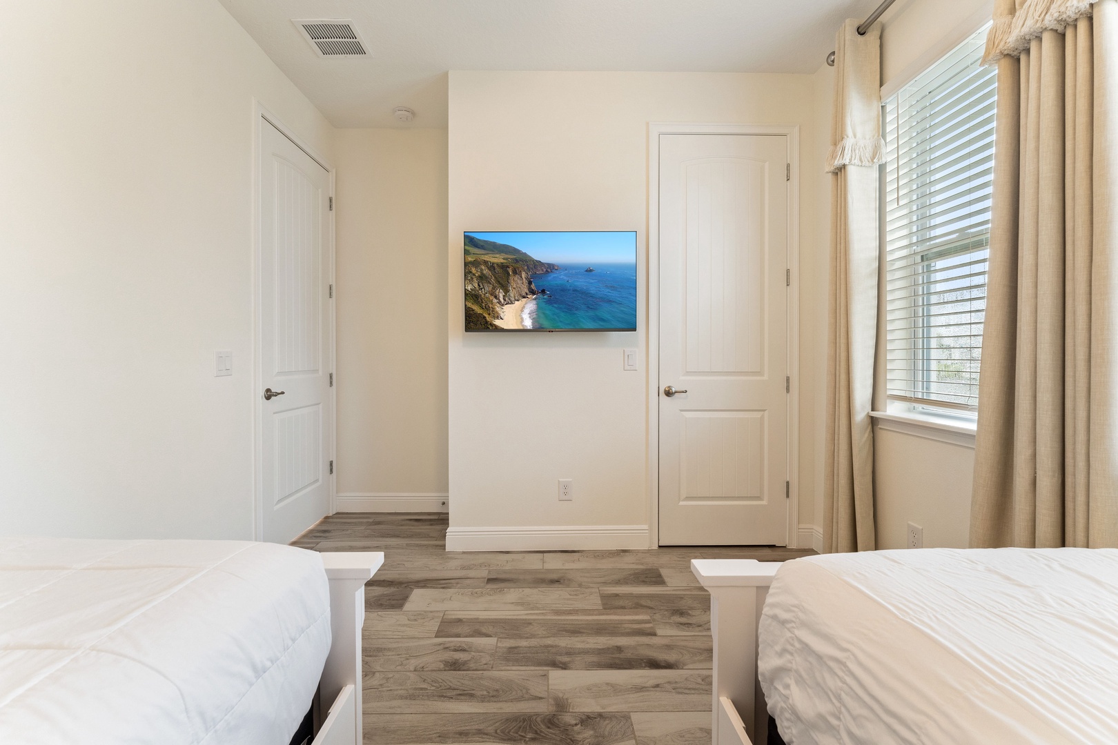 The first bedroom retreat offers two plush twin beds & smart TV