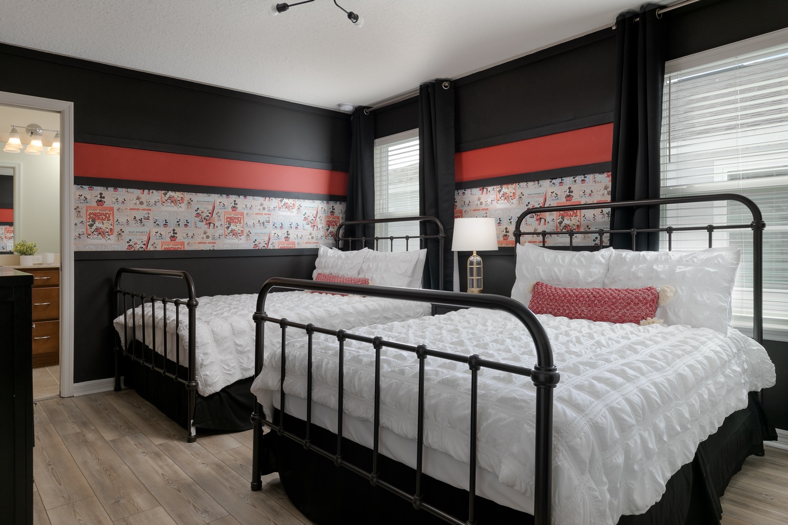 This 2nd floor bedroom offers a pair of full beds, private en suite, & Smart TV