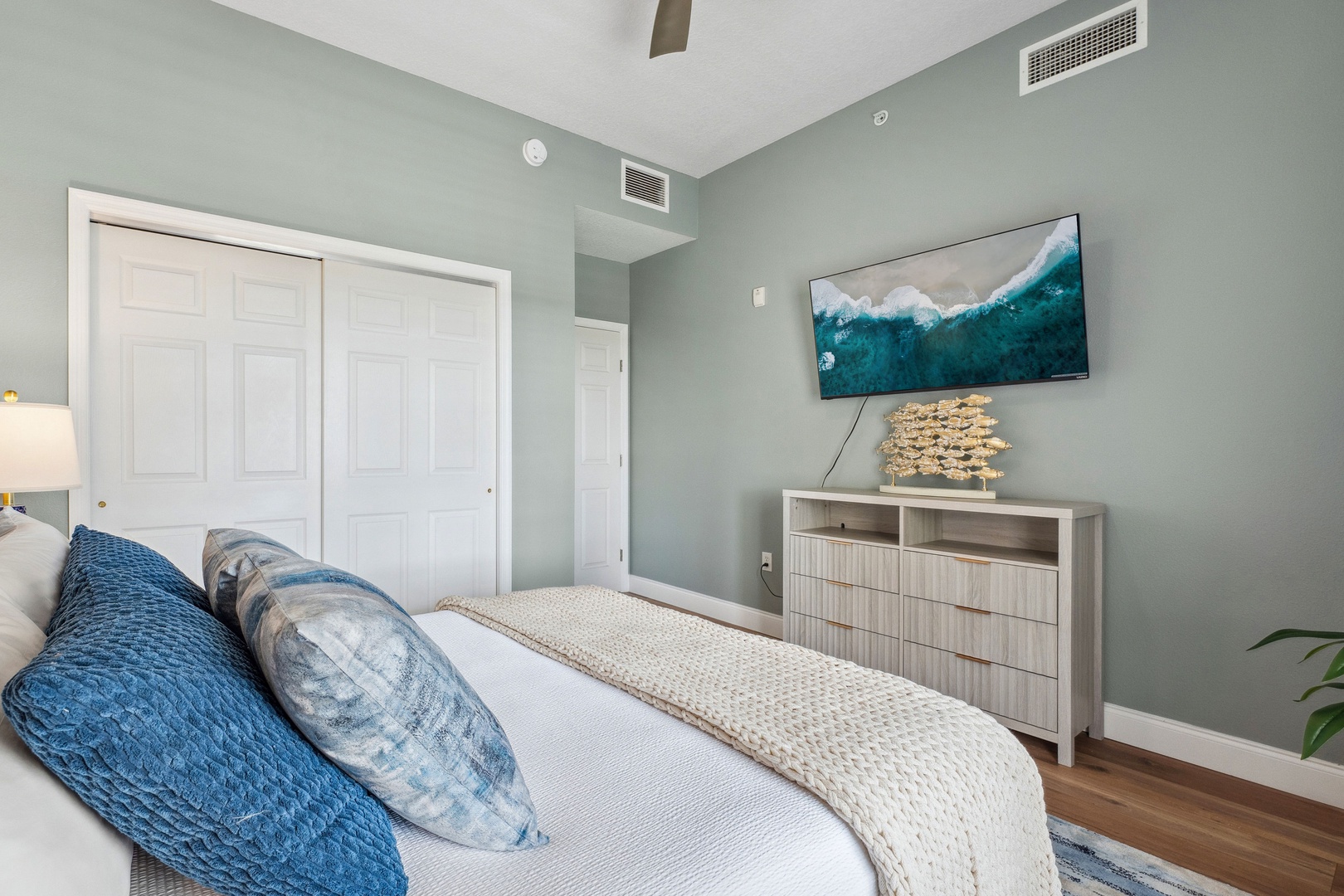 Recharge in the final bedroom, showcasing a regal queen bed & smart TV