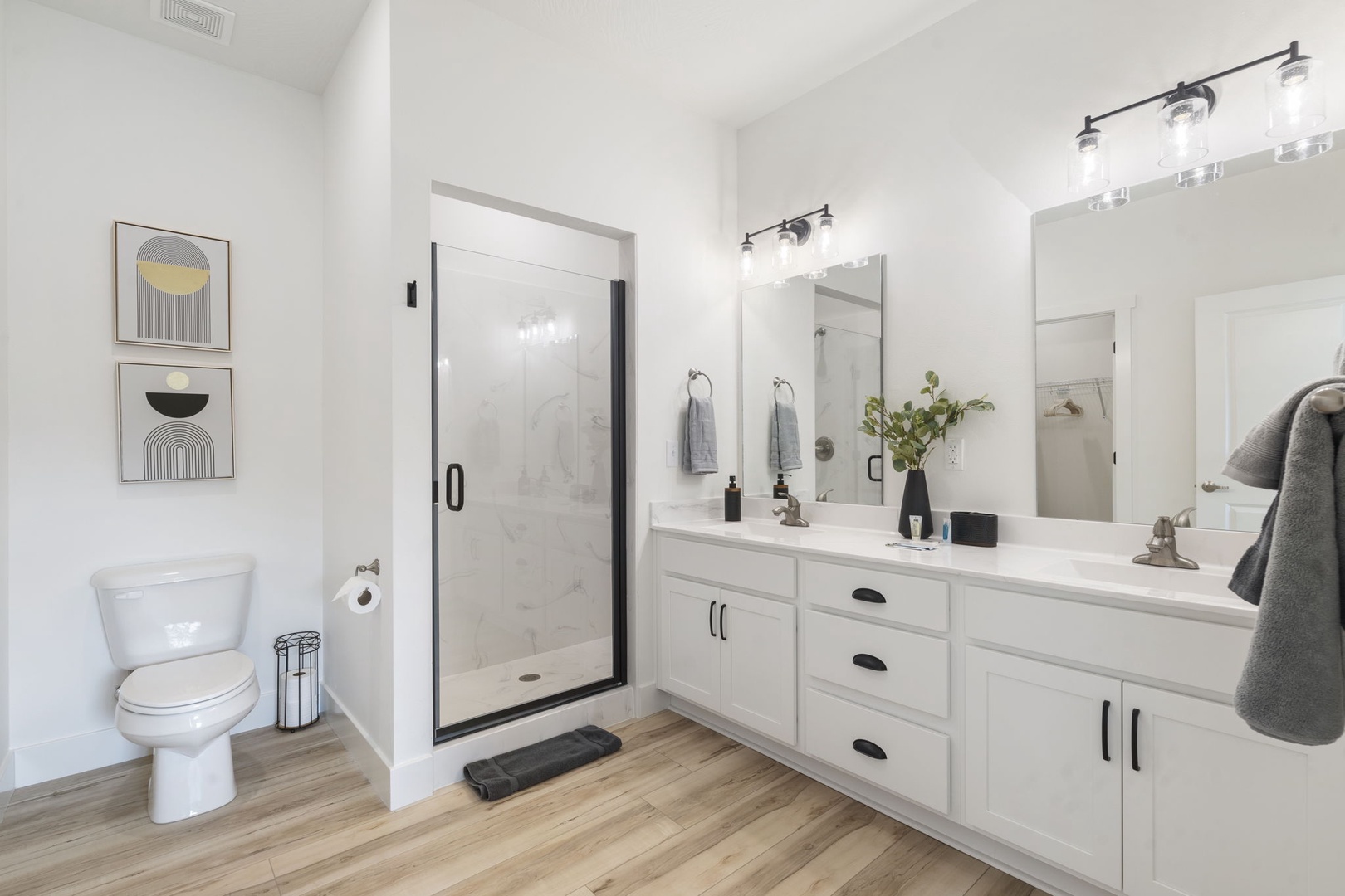 The king en suite boasts an oversized double vanity and glass shower
