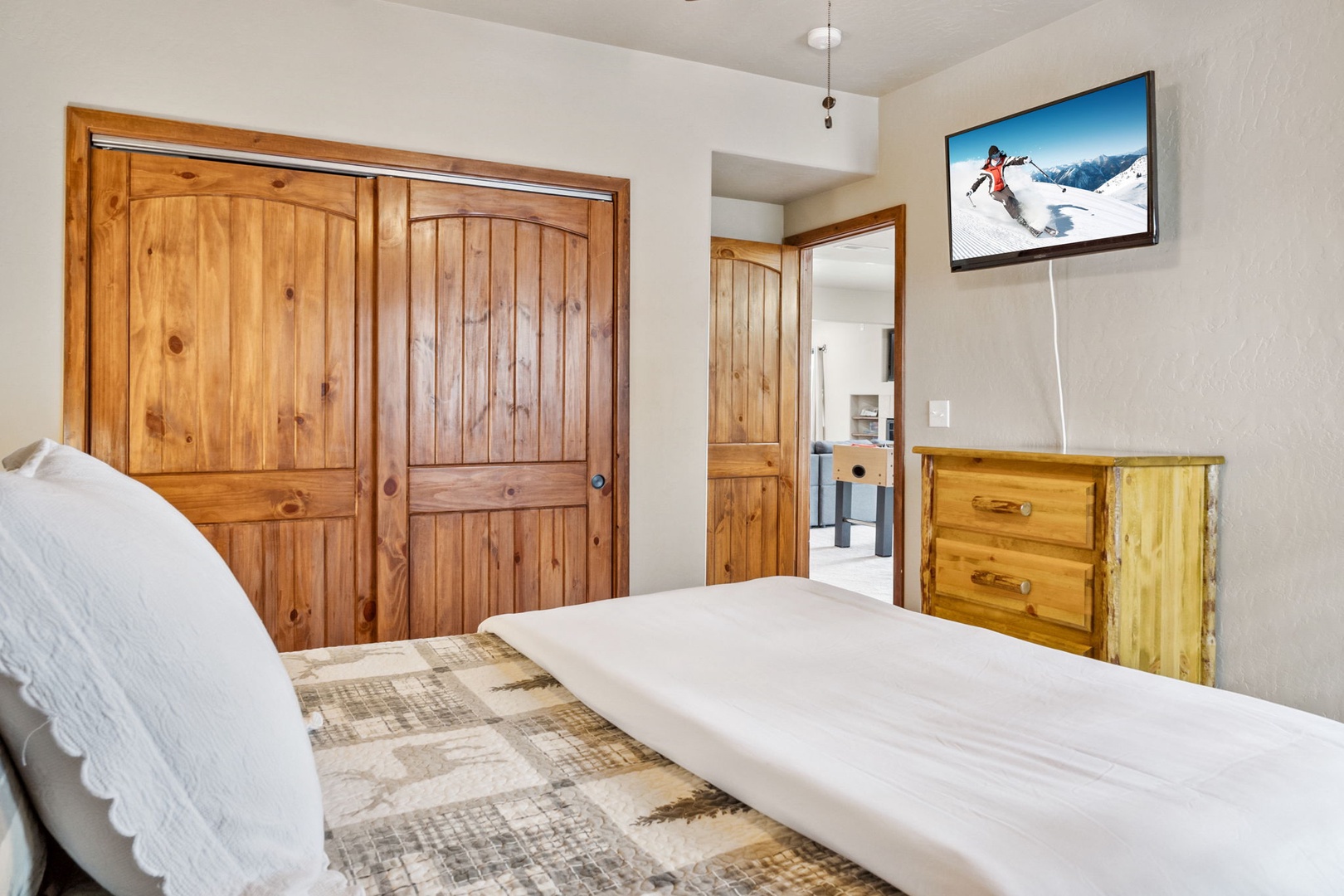 This lower-level queen bedroom with a smart TV is ideal for a snooze