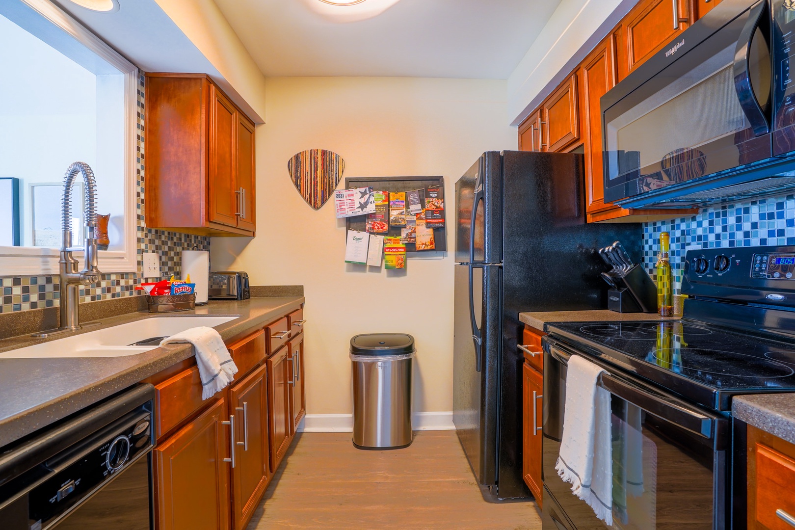 Kitchen with toaster, drip coffee maker, dishwasher, blender and more