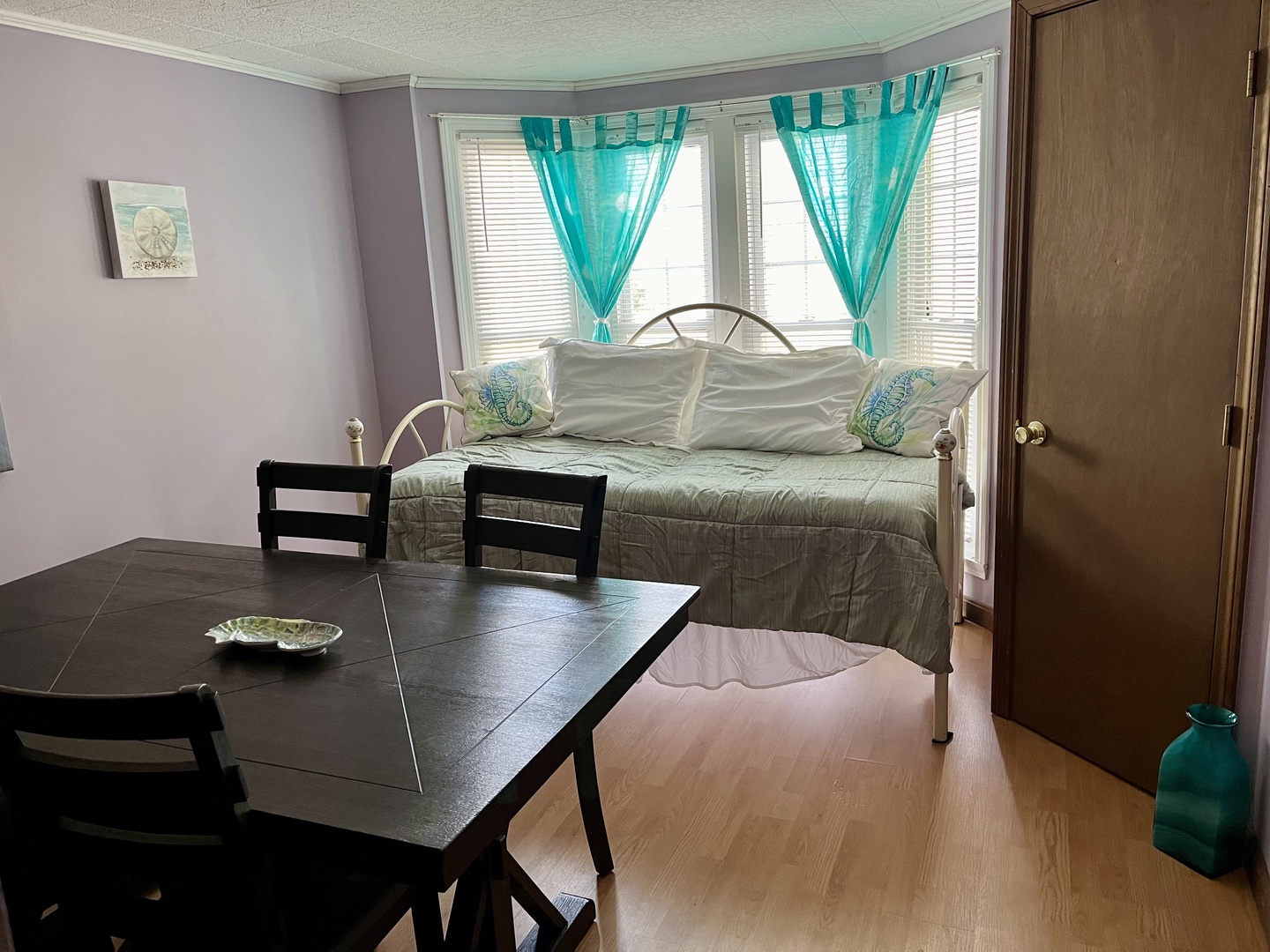 Bedroom 3 with twin daybed and dining table