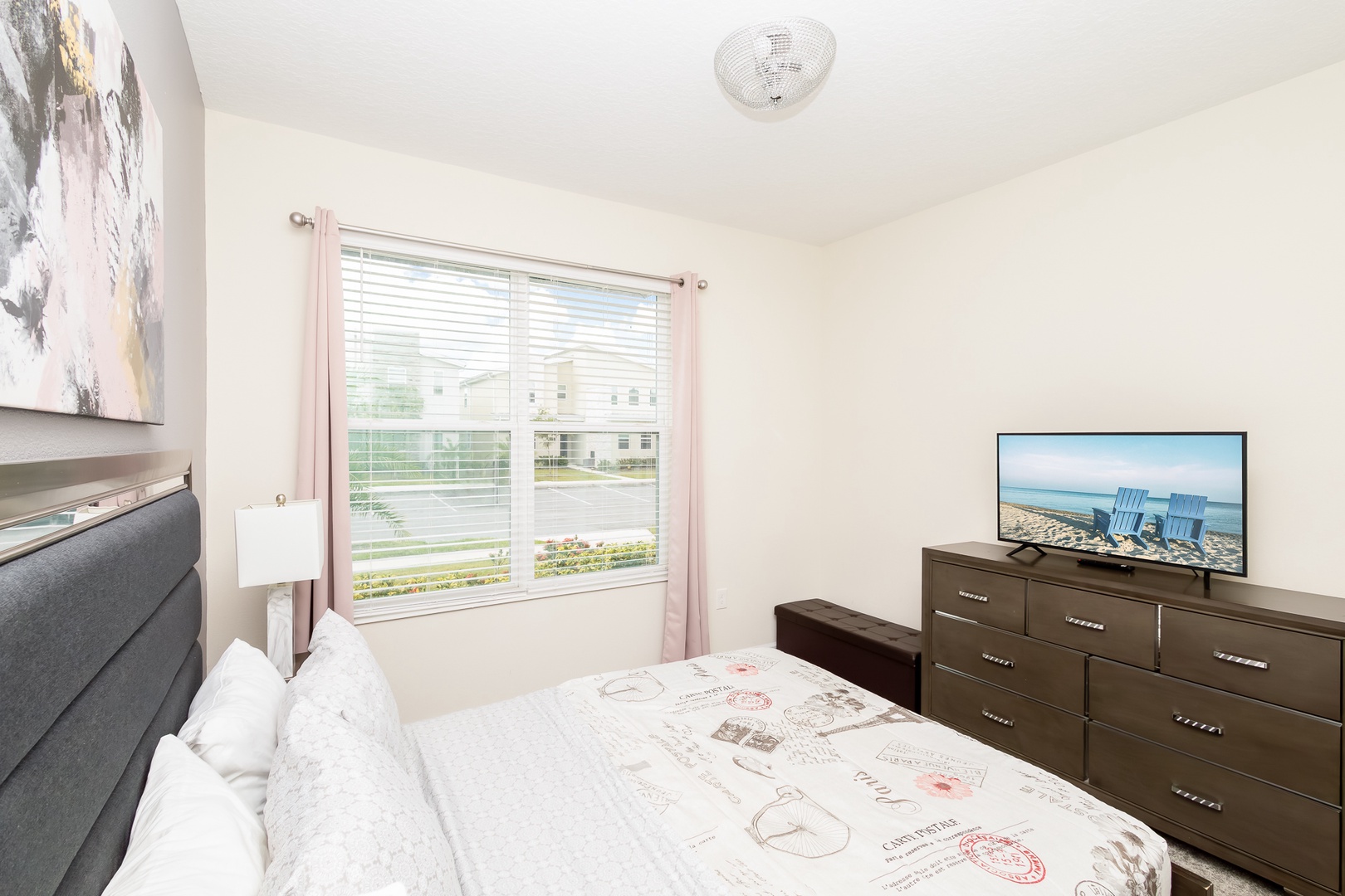 The second 1st-floor bedroom retreat features a plush queen bed & smart TV