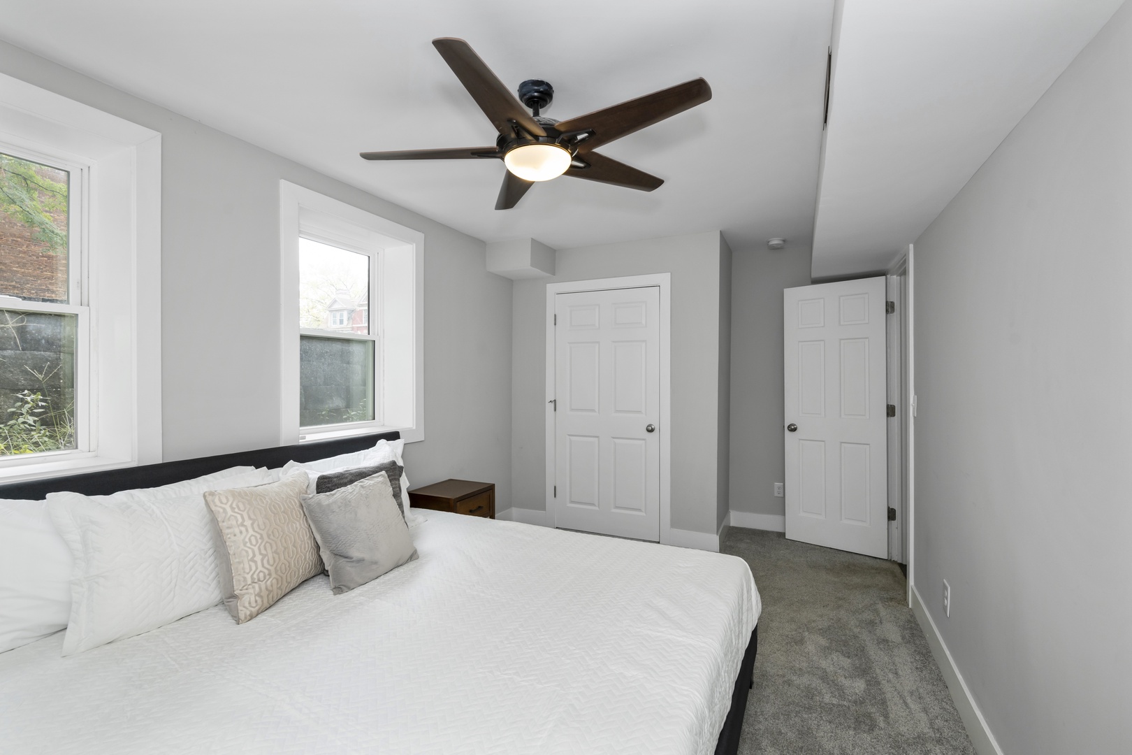 The lower-level king bedroom offers a ceiling fan & lots of privacy