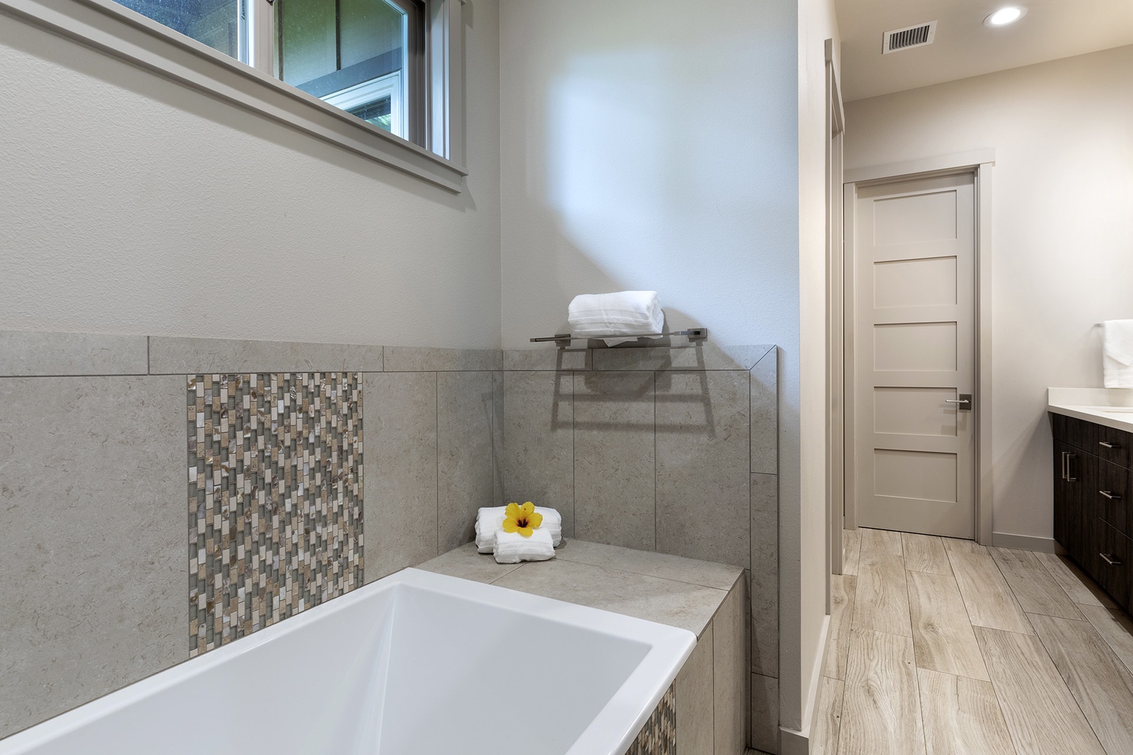 Master ensuite with dual sinks, walk-in shower, and soaking tub