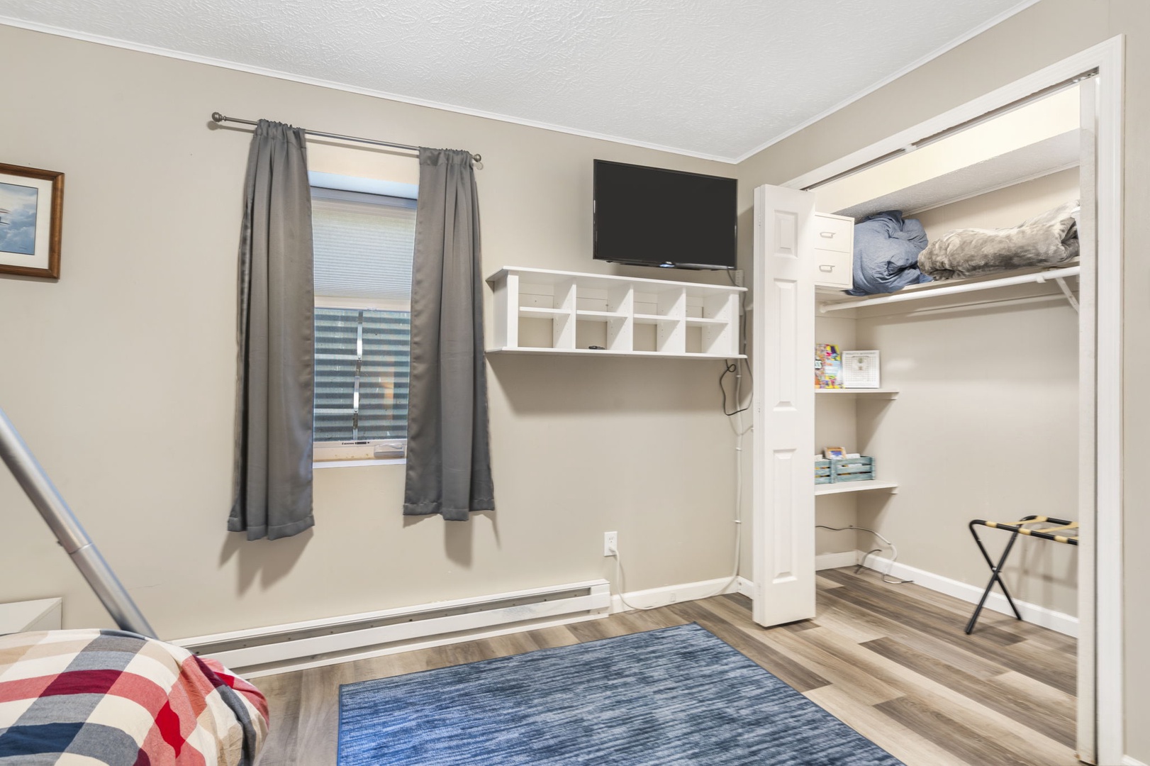 This lower-level bedroom includes a twin-over-full bunkbed, twin trundle, & Smart TV