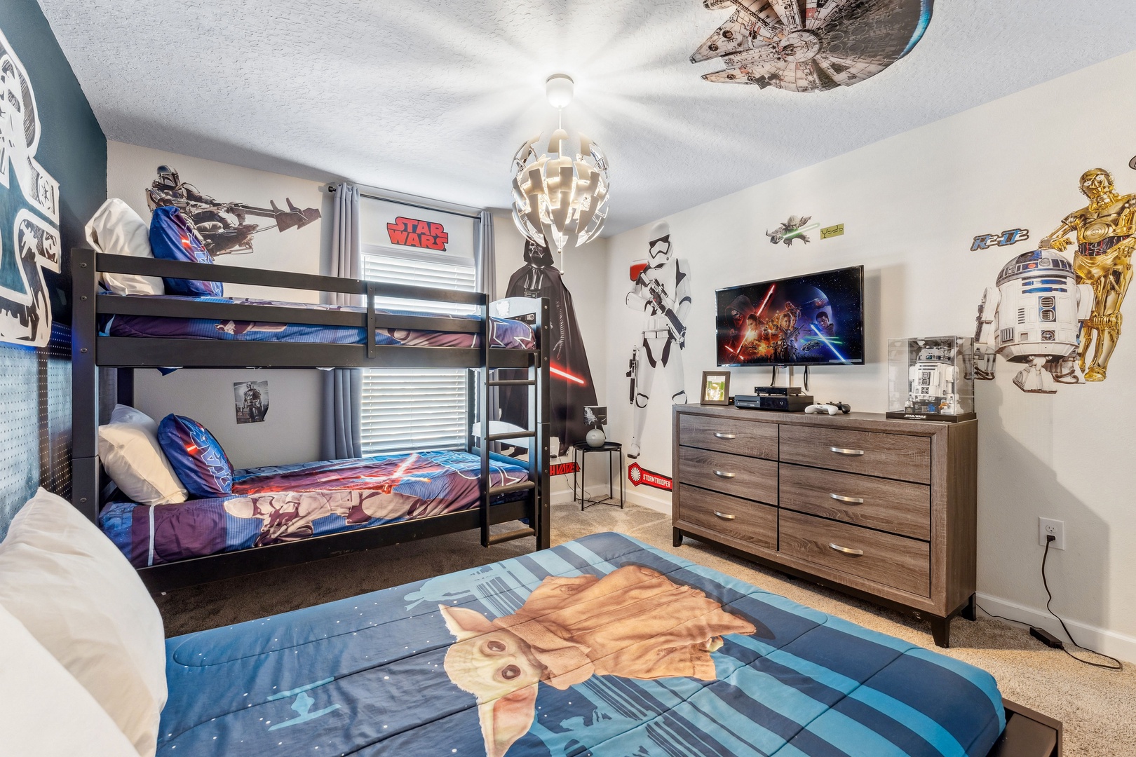 Epic Star Wars-themed bedroom featuring a twin bunk bed and full-size bed