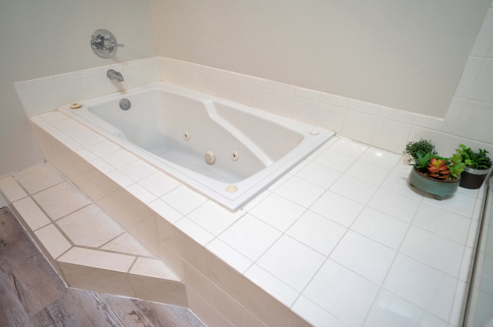 An oversized vanity, shower and soaking tub await in this large ensuite bath