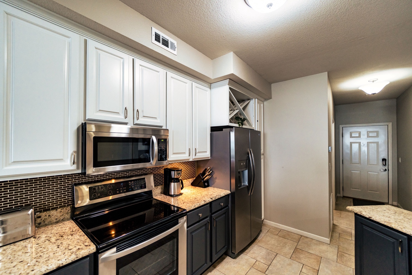 The airy, open kitchen offers ample storage & all the comforts of home