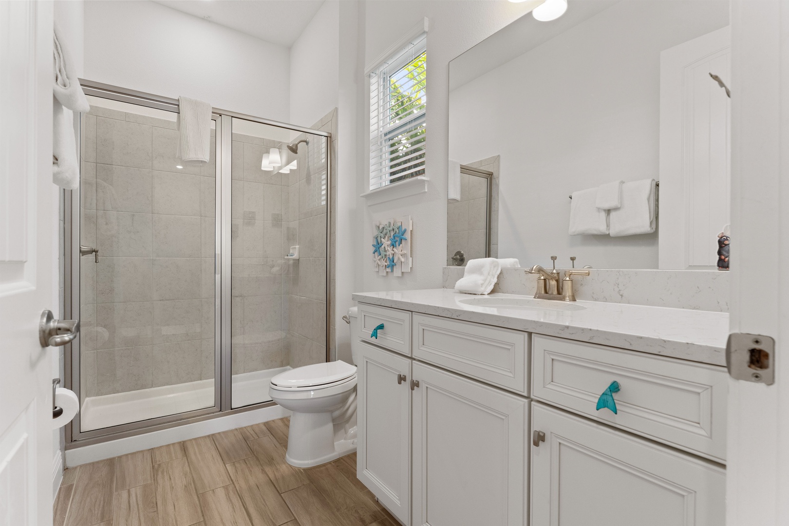 A single vanity & glass shower are available in this 2nd-floor full bath