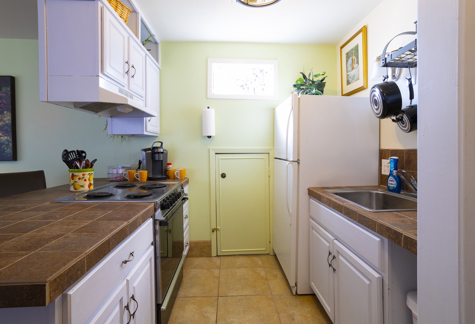 The airy kitchen offers ample space & all the comforts of home