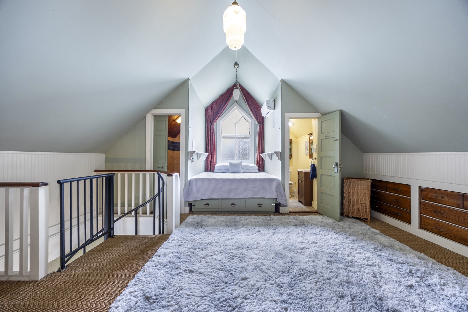 Recharge in the loft sleeping area, boasting a plush queen-sized bed