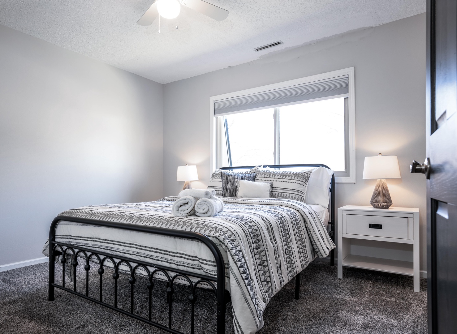 The second bedroom retreat showcases a cozy queen-sized bed & Smart TV