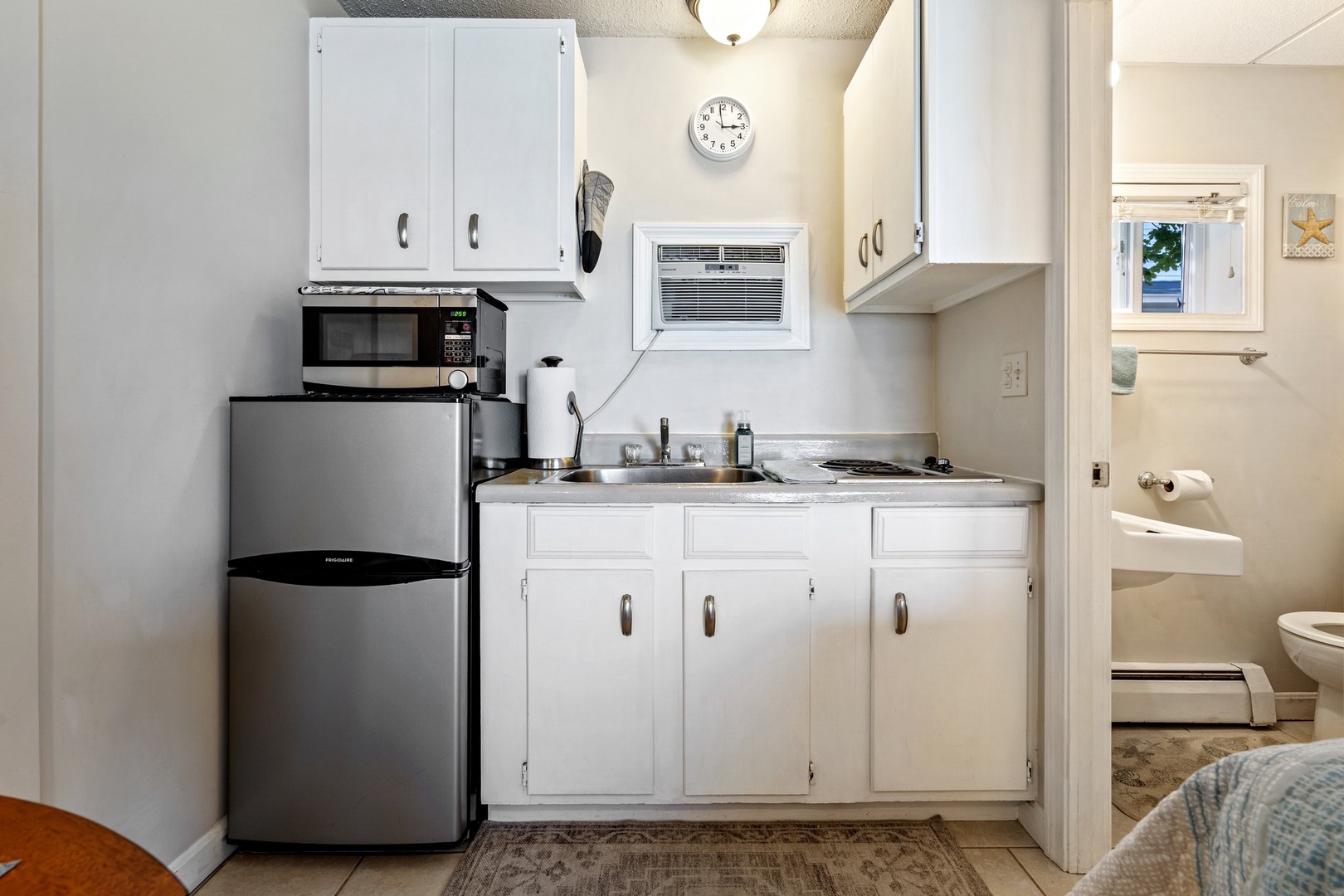 The cozy kitchenette offers ample storage & homey amenities