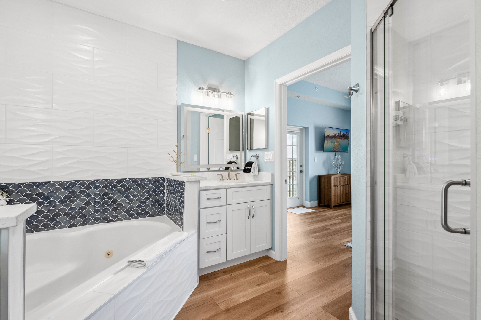 A pair of vanities, shower, & luxurious soaking tub awaits in the king ensuite