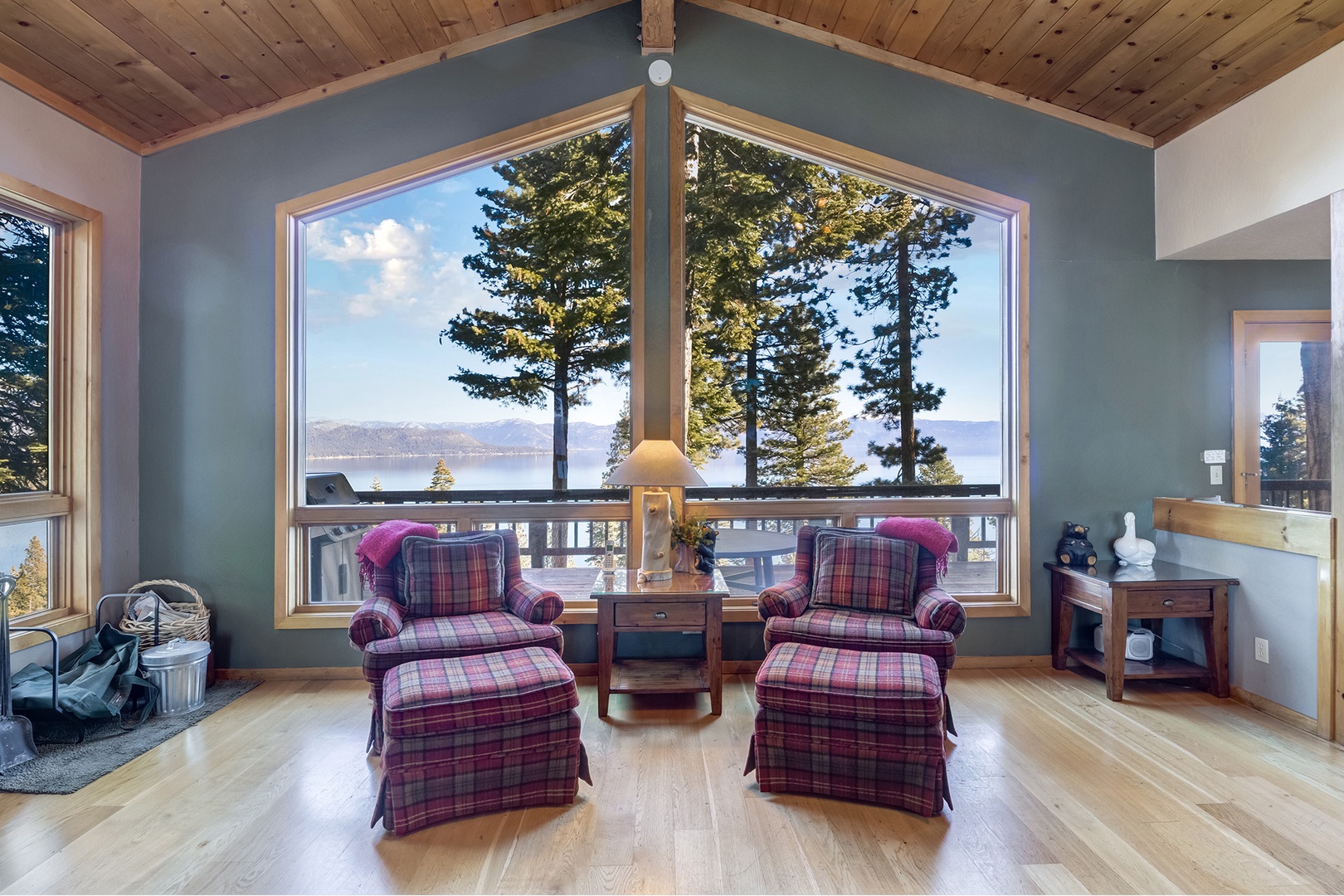 Cozy living room with a fireplace and stunning lake views through large windows