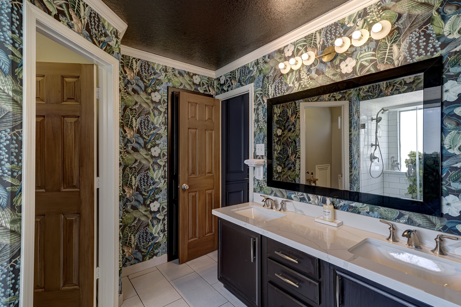 This ensuite features a double vanity, walk-in closet, & luxurious glass shower