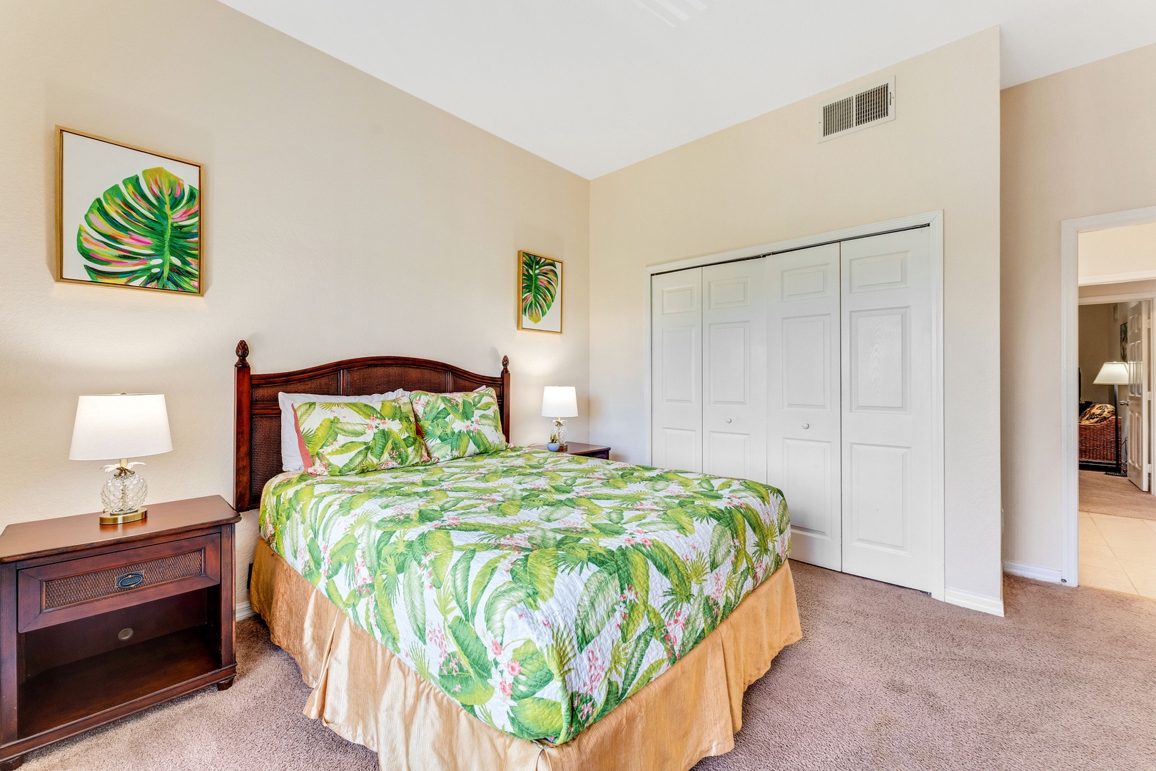 Bedroom 2 with queen bed, TV, balcony, and ensuite