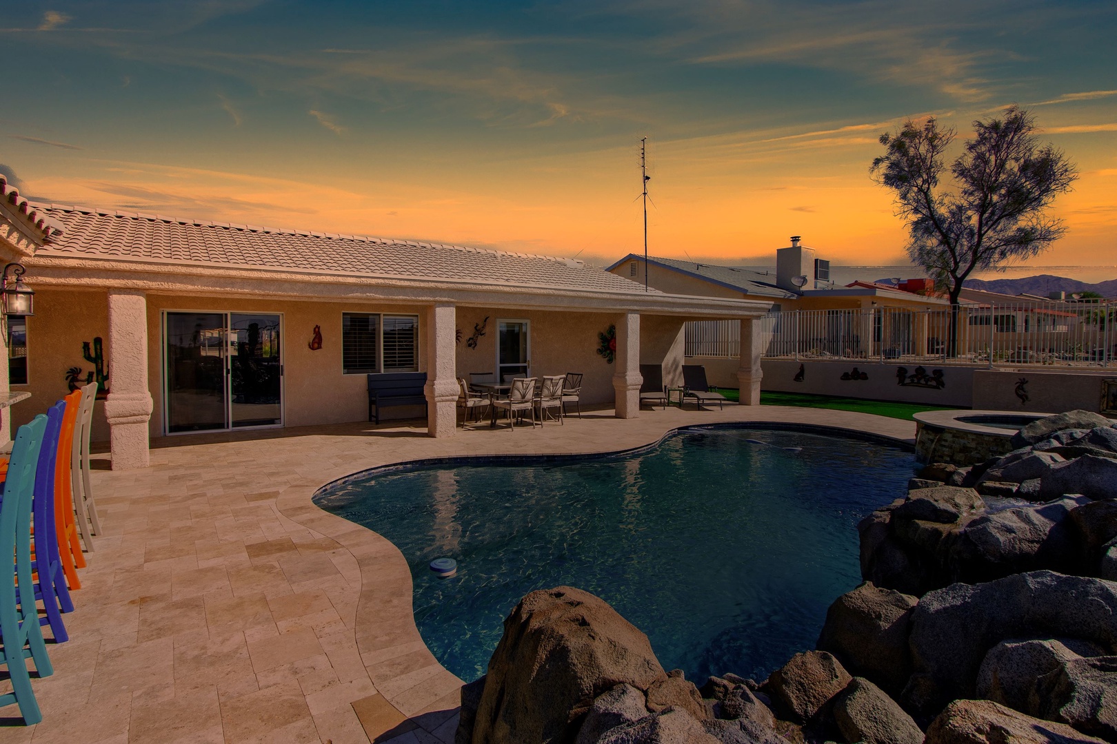 A mountain-view oasis, with a waterfall pool, hot tub, & outdoor kitchen!