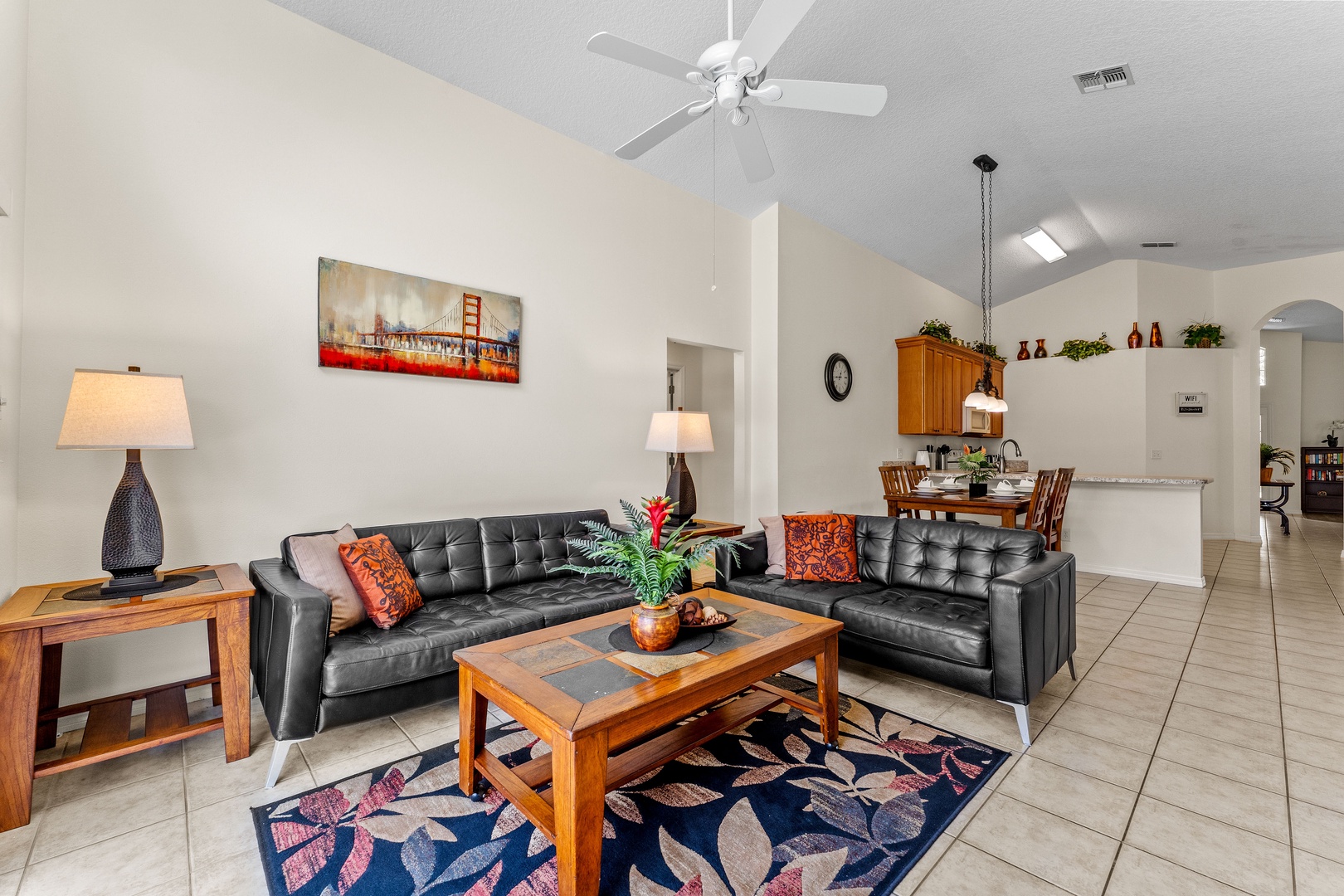 Rear living room with cozy seating and ceiling fan and access to lanai