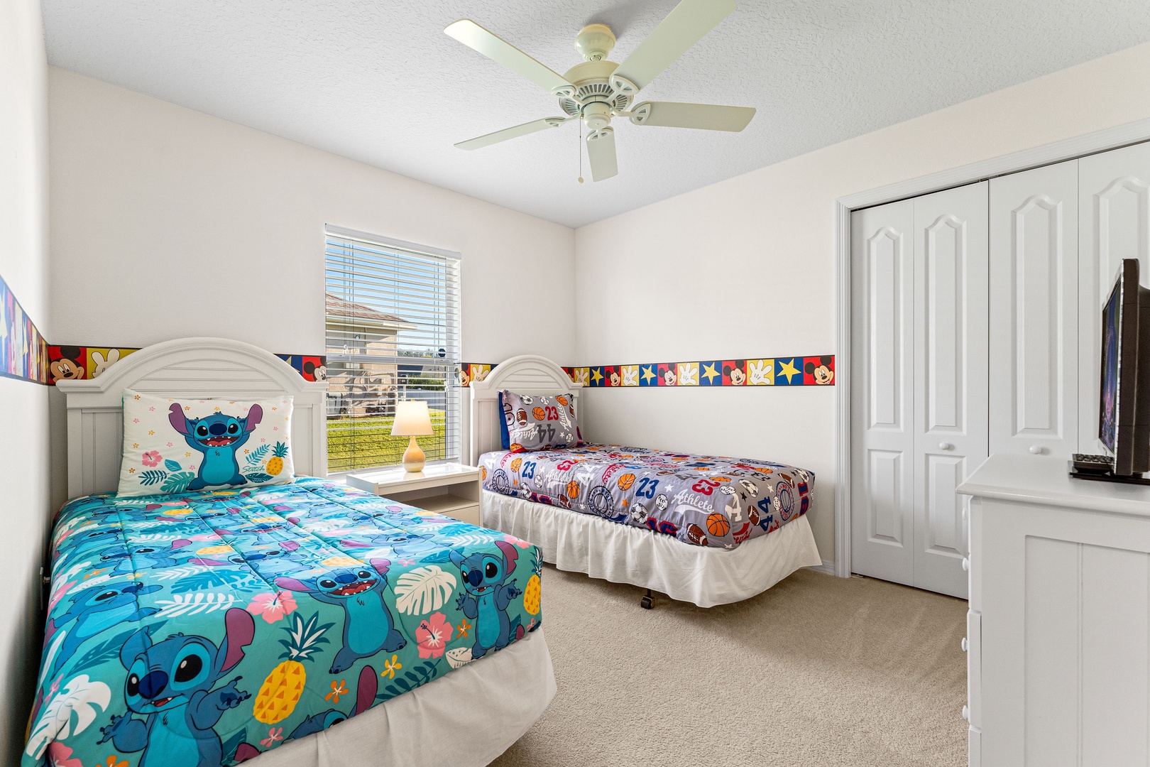 Bedroom 2 Mickey Mouse themed with 2 twin beds and Smart tV